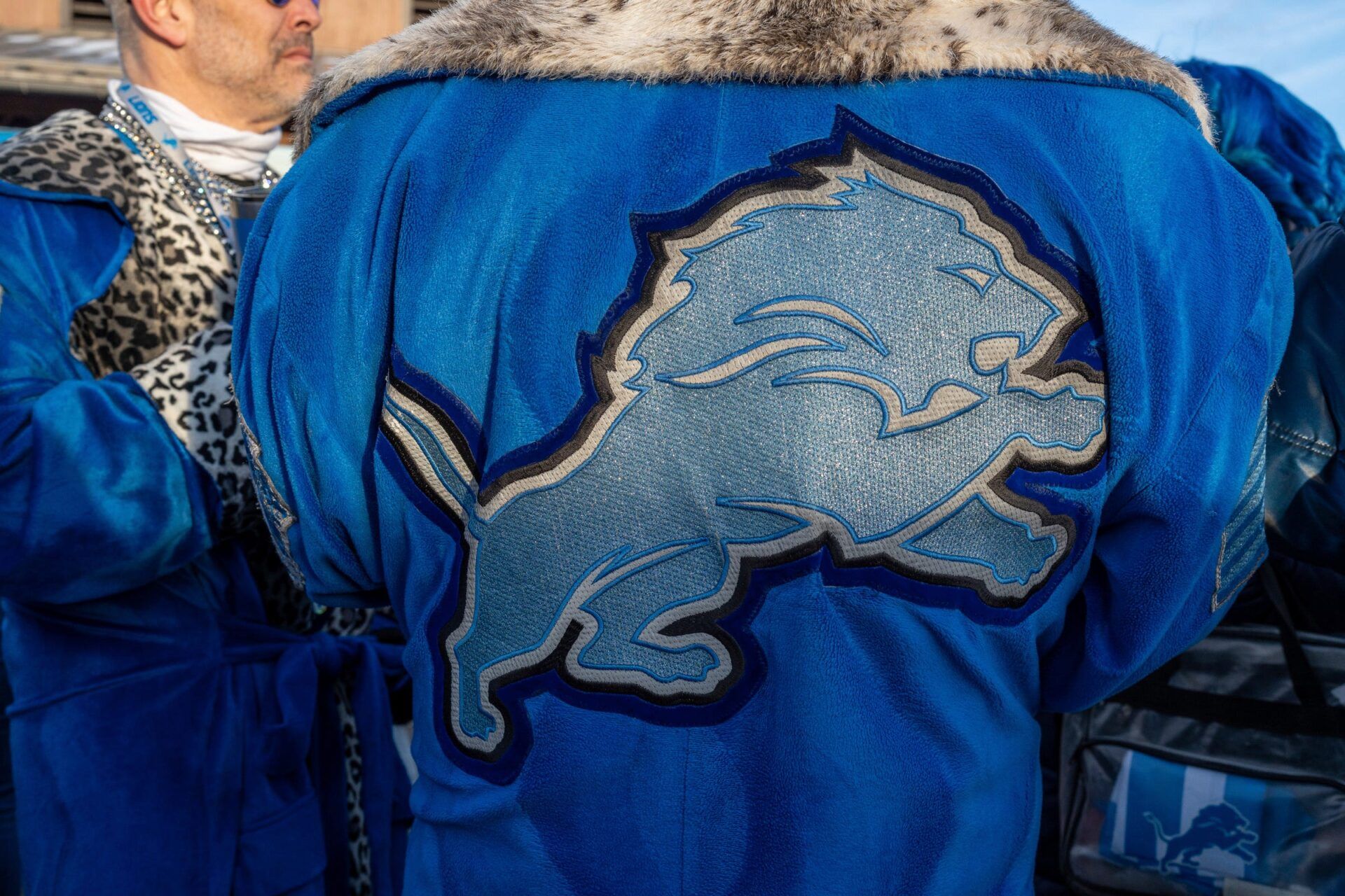 A Detroit Lions fan wears a robe with the Lions logo on it during a tailgate at Eastern Market before the Lions vs. Washington Commanders playoff game in Detroit on Saturday, Jan. 18, 2025. © David Rodriguez Munoz / USA TODAY NETWORK via Imagn Images