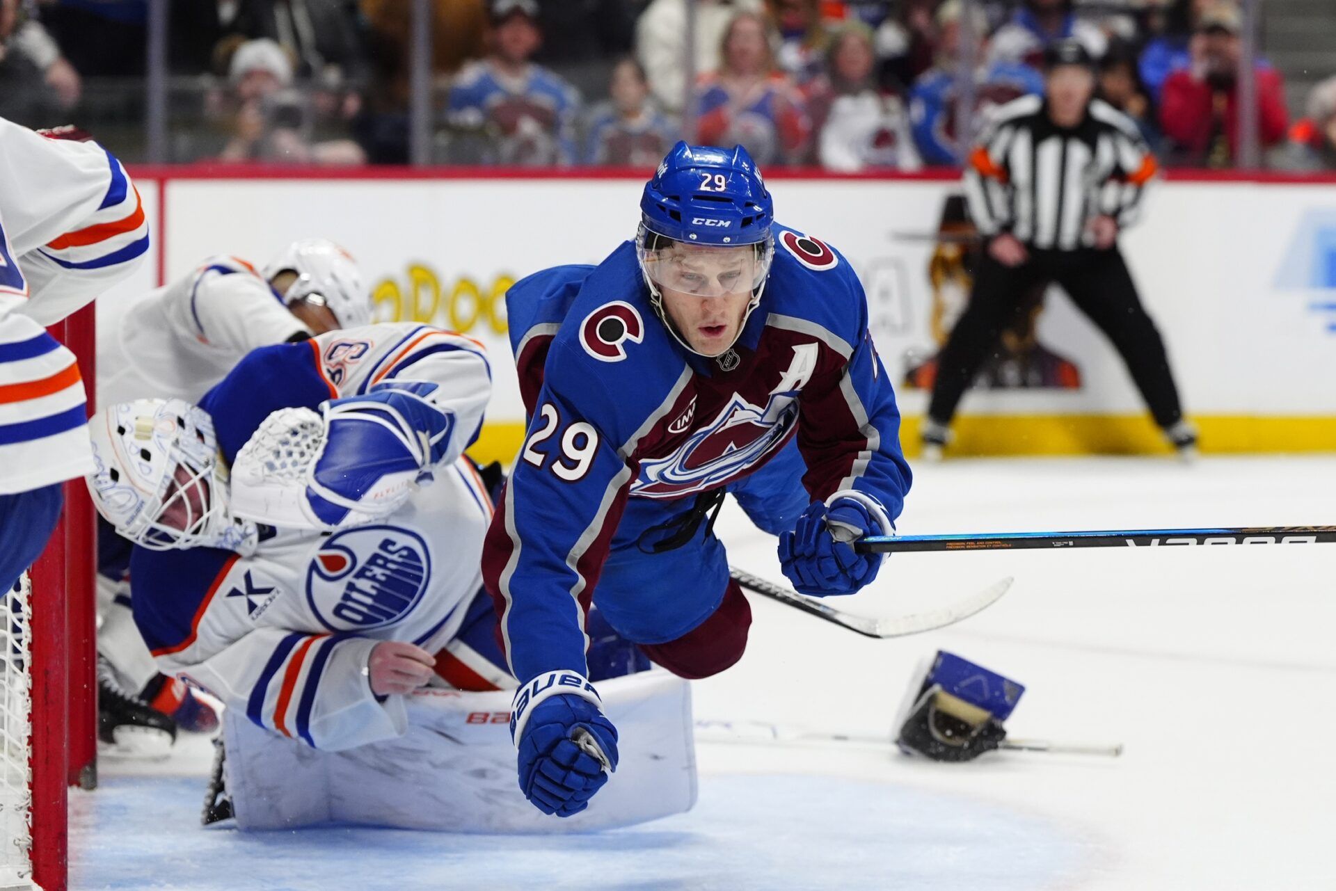Colorado Avalanche center Nathan MacKinnon (29) collides into Edmonton Oilers goaltender Connor Ingram (39) in the second period at Ball Arena.