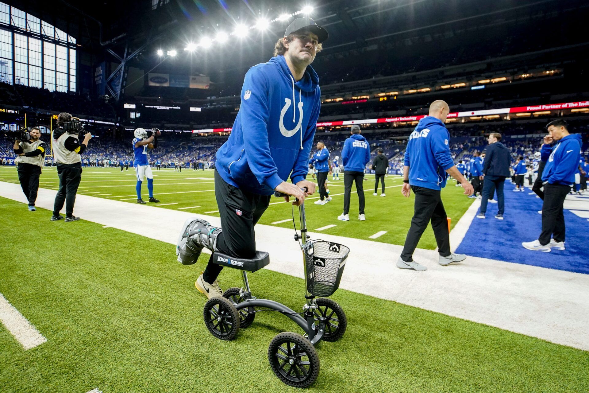 Indianapolis Colts quarterback Daniel Jones moves along the sideline on a scooter Sunday, Dec. 28, 2025, ahead a game against the Jacksonville Jaguars at Lucas Oil Stadium in Indianapolis.