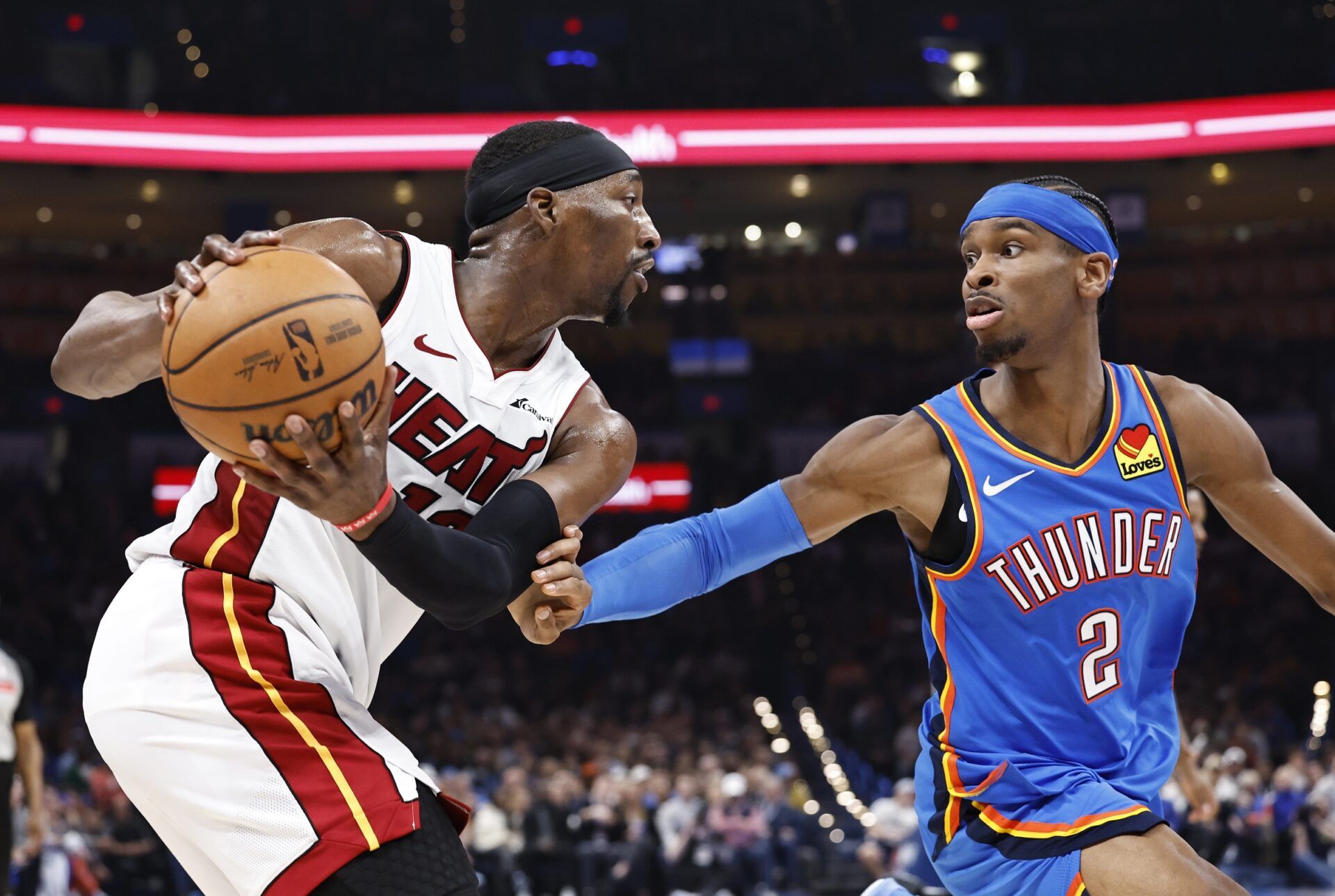 Miami Heat center Bam Adebayo (13) is defended by Oklahoma City Thunder guard Shai Gilgeous-Alexander (2) on a play during the second quarter at Paycom Center.
