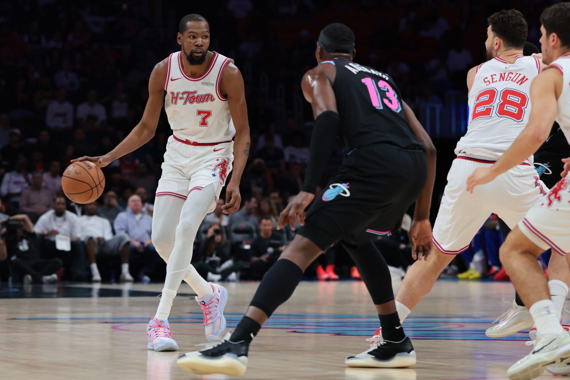 Houston Rockets forward Kevin Durant (7) dribbles the basketball against Miami Heat center Bam Adebayo (13) during the first quarter at Kaseya Center.