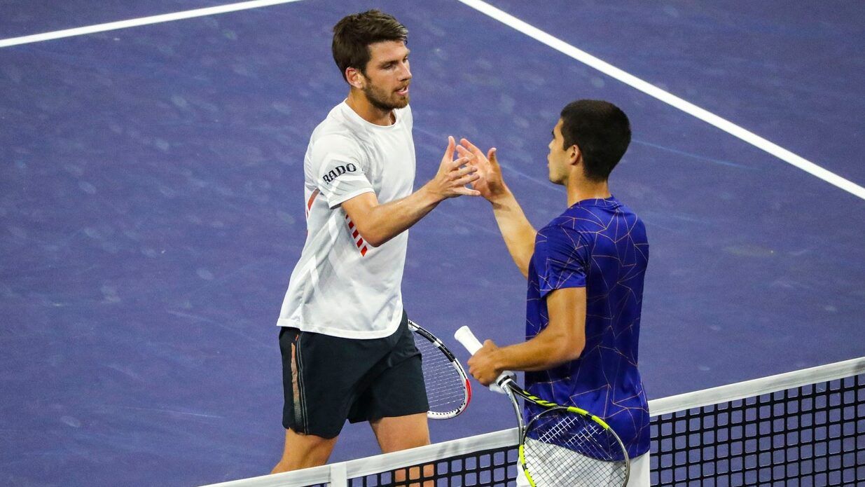 Cameron Norrie of Great Britain (left) shakes hands with Carlos Alcaraz of Spain after Alcaraz wins their quarterfinal match at the BNP Paribas Open at the Indian Wells Tennis Garden in Indian Wells, Calif., Thursday, March 17, 2022.