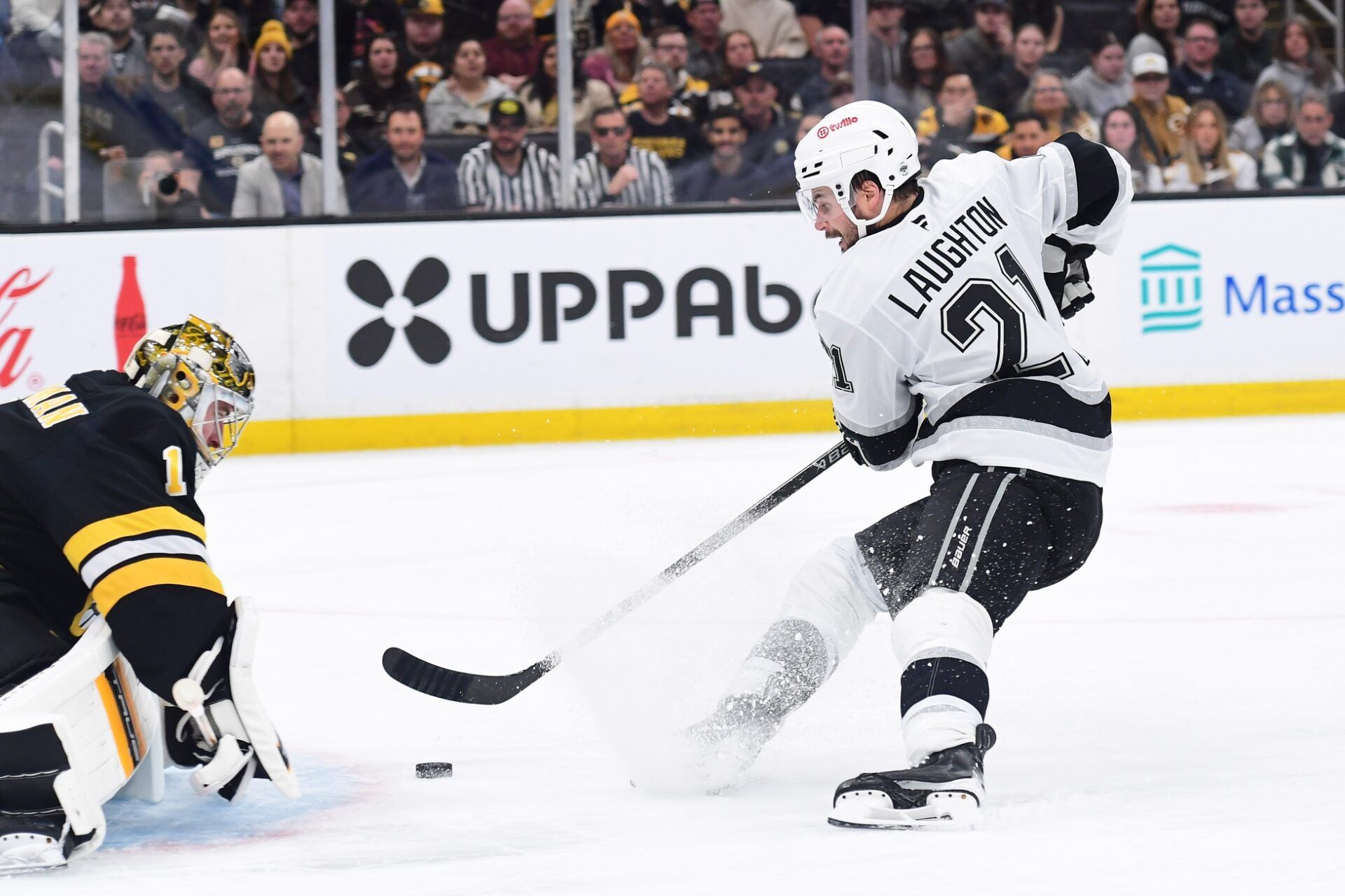 Los Angeles Kings center Scott Laughton (21) skates in alone on Boston Bruins goaltender Jeremy Swayman (1) during the second period at TD Garden.
