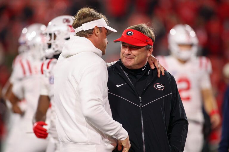 Mississippi Rebels head coach Lane Kiffin talks to Georgia Bulldogs head coach Kirby Smart before a game at Sanford Stadium.