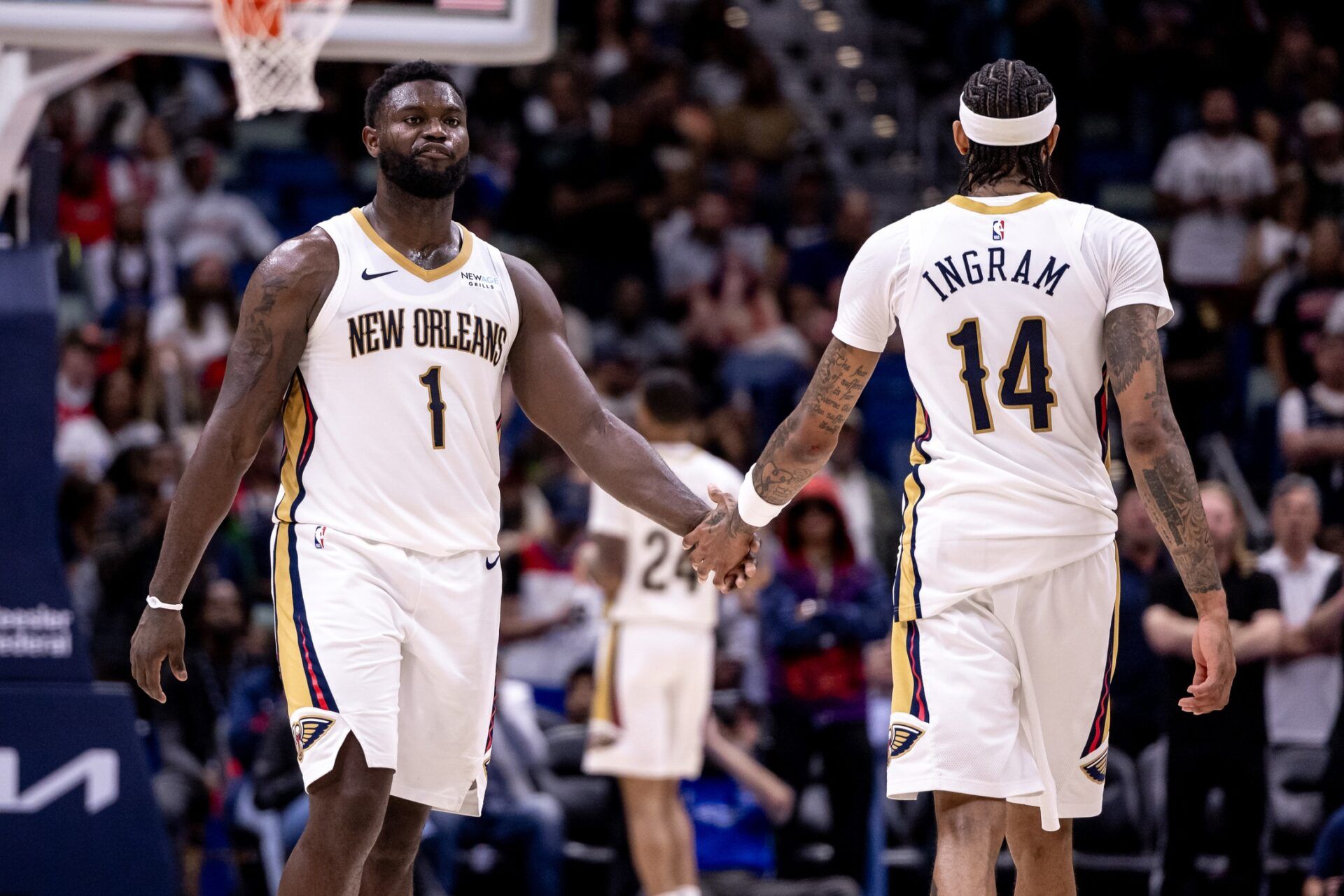 New Orleans Pelicans forward Brandon Ingram (14) slaps hands with forward Zion Williamson (1) after a play against the Indiana Pacers during the second half at Smoothie King Center.