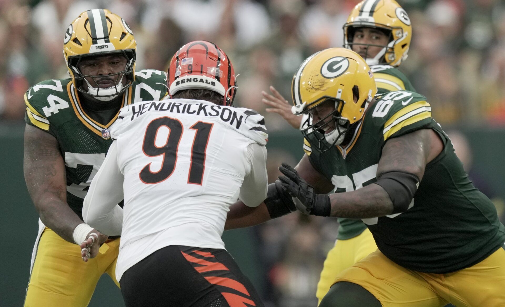 Cincinnati Bengals defensive end Trey Hendrickson (91) is double-teamed by Green Bay Packers center Elgton Jenkins (74) and guard Aaron Banks (65) during the second quarter of their game at Lambeau Field.