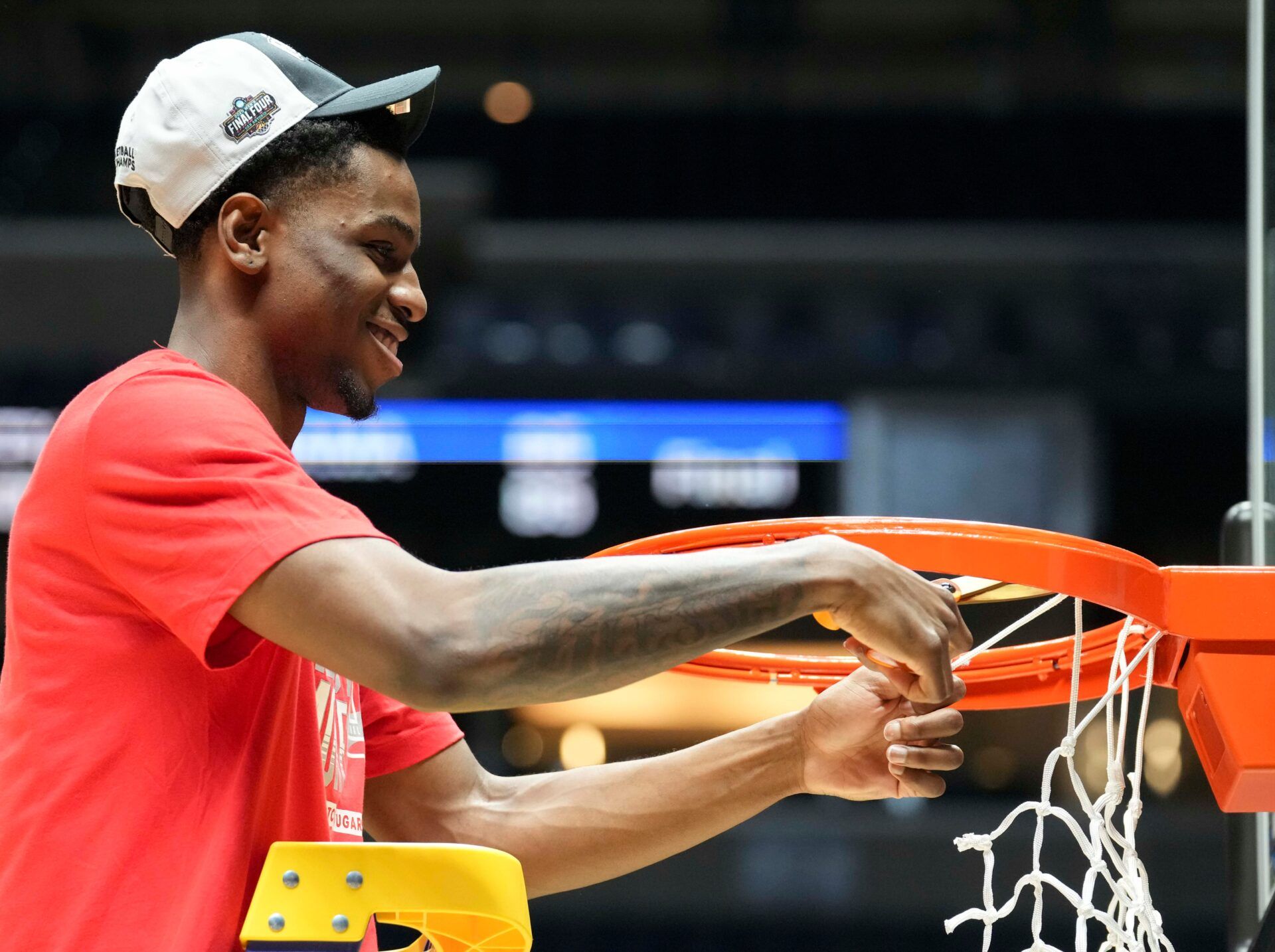 Houston Cougars guard Terrance Arceneaux (23) cuts a piece of the net following his team’s win against the Tennessee Volunteers in a game Sunday, March 30, 2025, during the Elite Eight round of the NCAA March Madness tournament at Lucas Oil Stadium in Indianapolis. Houston defeated Tennessee 69-50. © Christine Tannous/IndyStar / USA TODAY NETWORK via Imagn Images