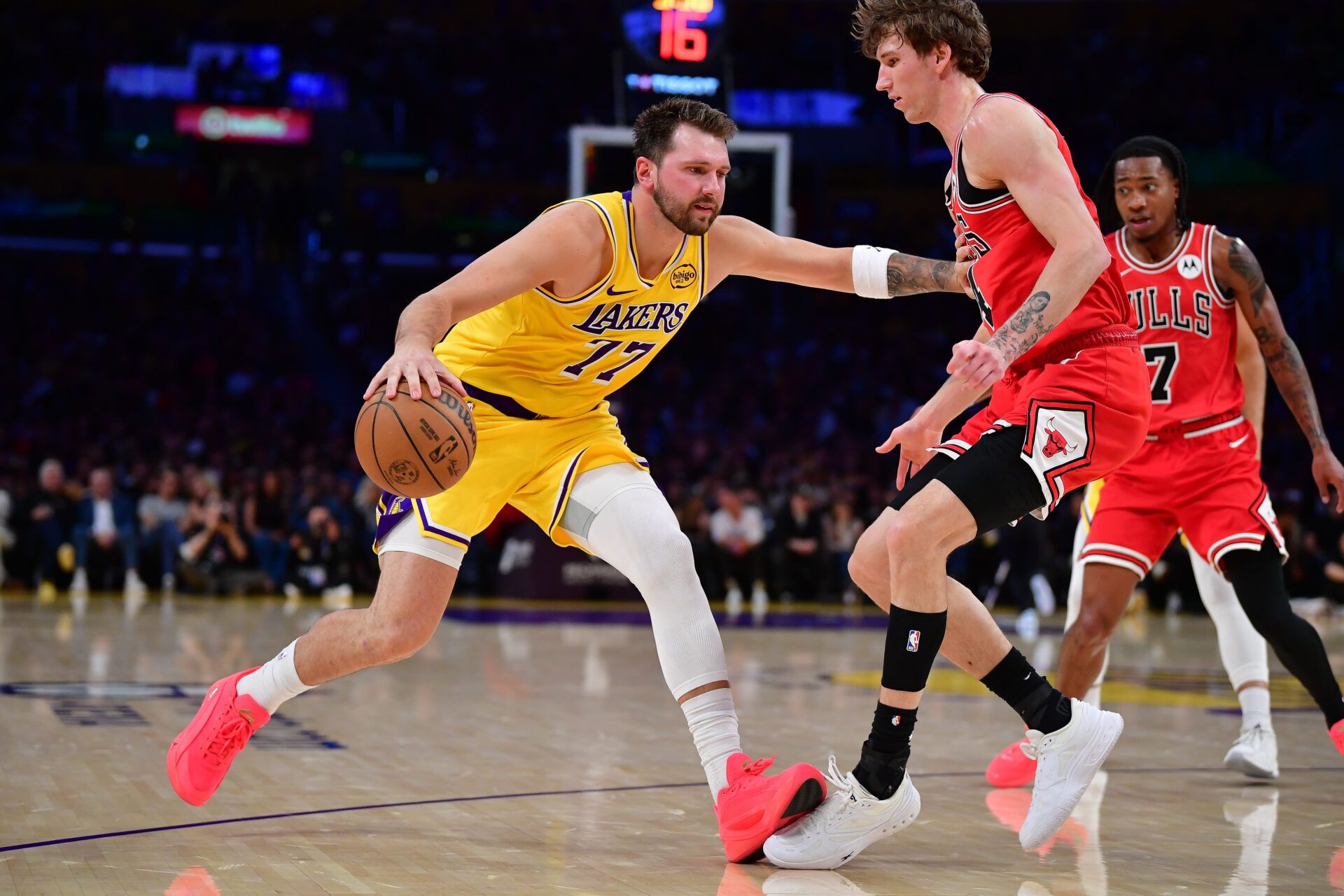 Los Angeles Lakers guard Luka Doncic (77) moves the ball against Chicago Bulls forward Matas Buzelis (14) during the first half at Crypto.com Arena.