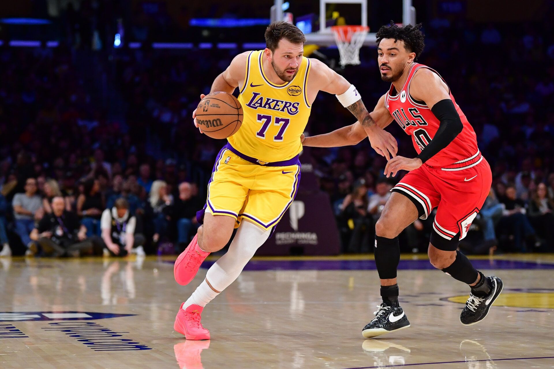 Los Angeles Lakers guard Luka Doncic (77) moves the ball against Chicago Bulls guard Tre Jones (30) during the first half at Crypto.com Arena.