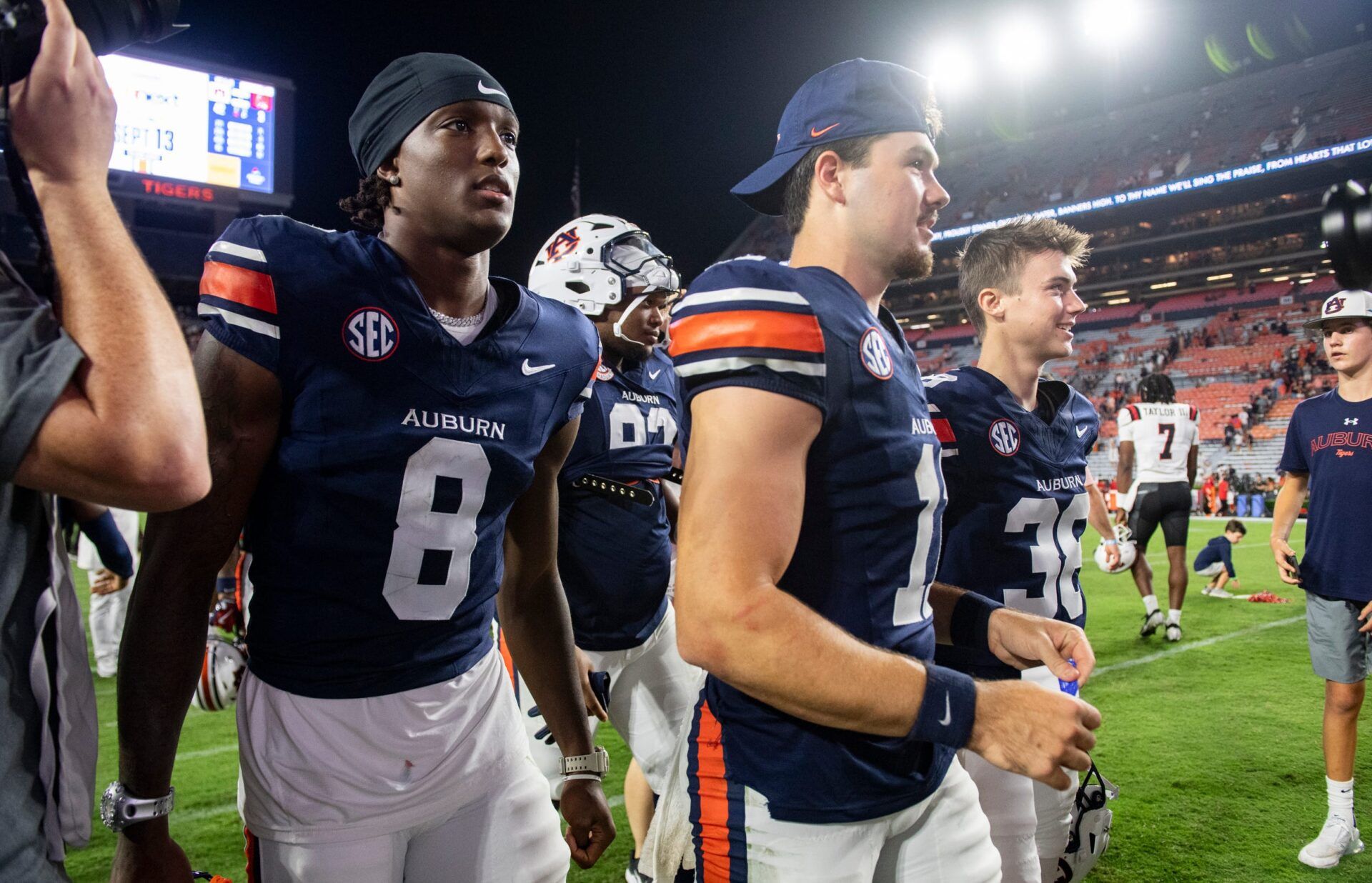 Auburn Tigers wide receiver Cam Coleman (8), defensive lineman Jay Hardy (92), quarterback Jackson Arnold (11), and kicker Alex McPherson (38) walk off the field together after the game as Auburn Tigers take on Ball State Cardinals at Jordan-Hare Stadium in Auburn, Ala. on Saturday, Sept. 6, 2025. Auburn Tigers defeated Ball State Cardinals 42-3.