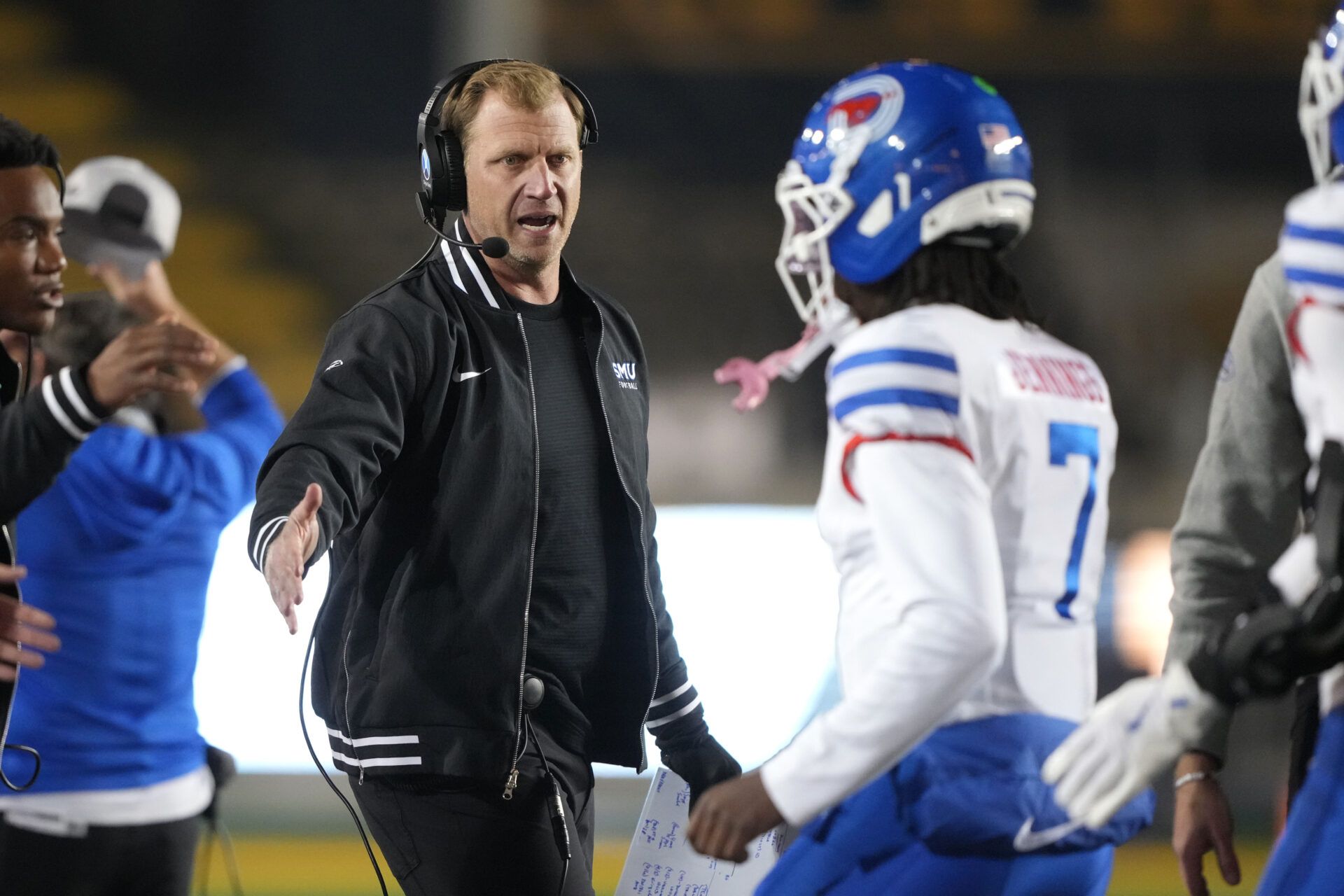 Southern Methodist Mustangs quarterback Kevin Jennings (7) is congratulated by head coach Rhett Lashlee (center left) after scoring a touchdown against the California Golden Bears during the fourth quarter at California Memorial Stadium.