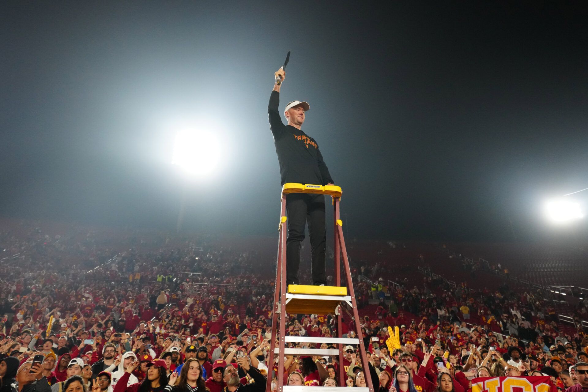 Southern California Trojans head coach Lincoln Riley leads the Spirit of Troy marching band in a rendition of Tribute to Troy after teh game against the UCLA Bruins at United Airlines Field at Los Angeles Memorial Coliseum.