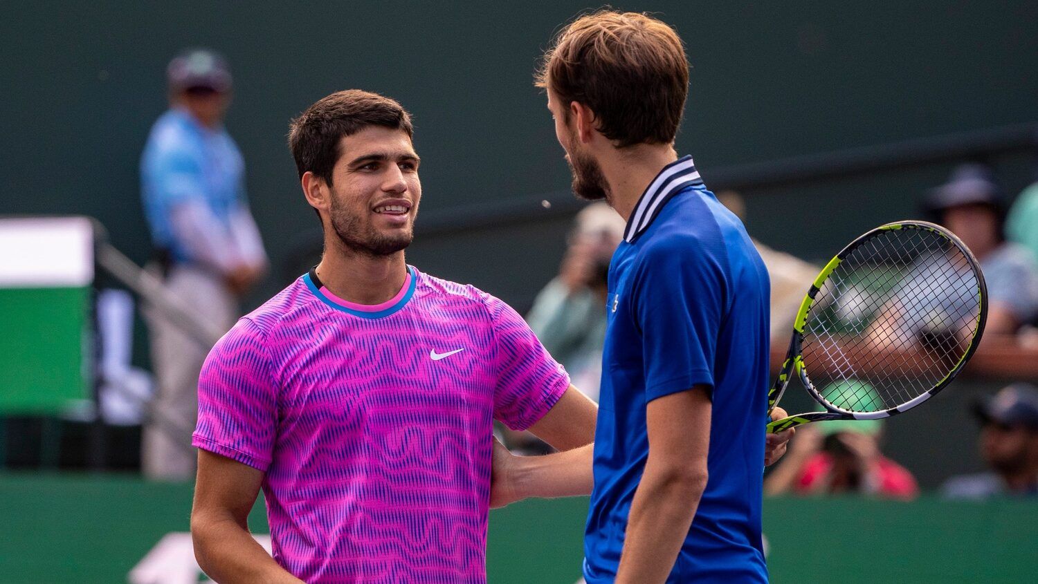 Carlos Alcaraz meets Daniil Medvedev at the net after he wins the ATP final of the BNP Paribas Open in Indian Wells, Calif., Sunday, March 17, 2024.