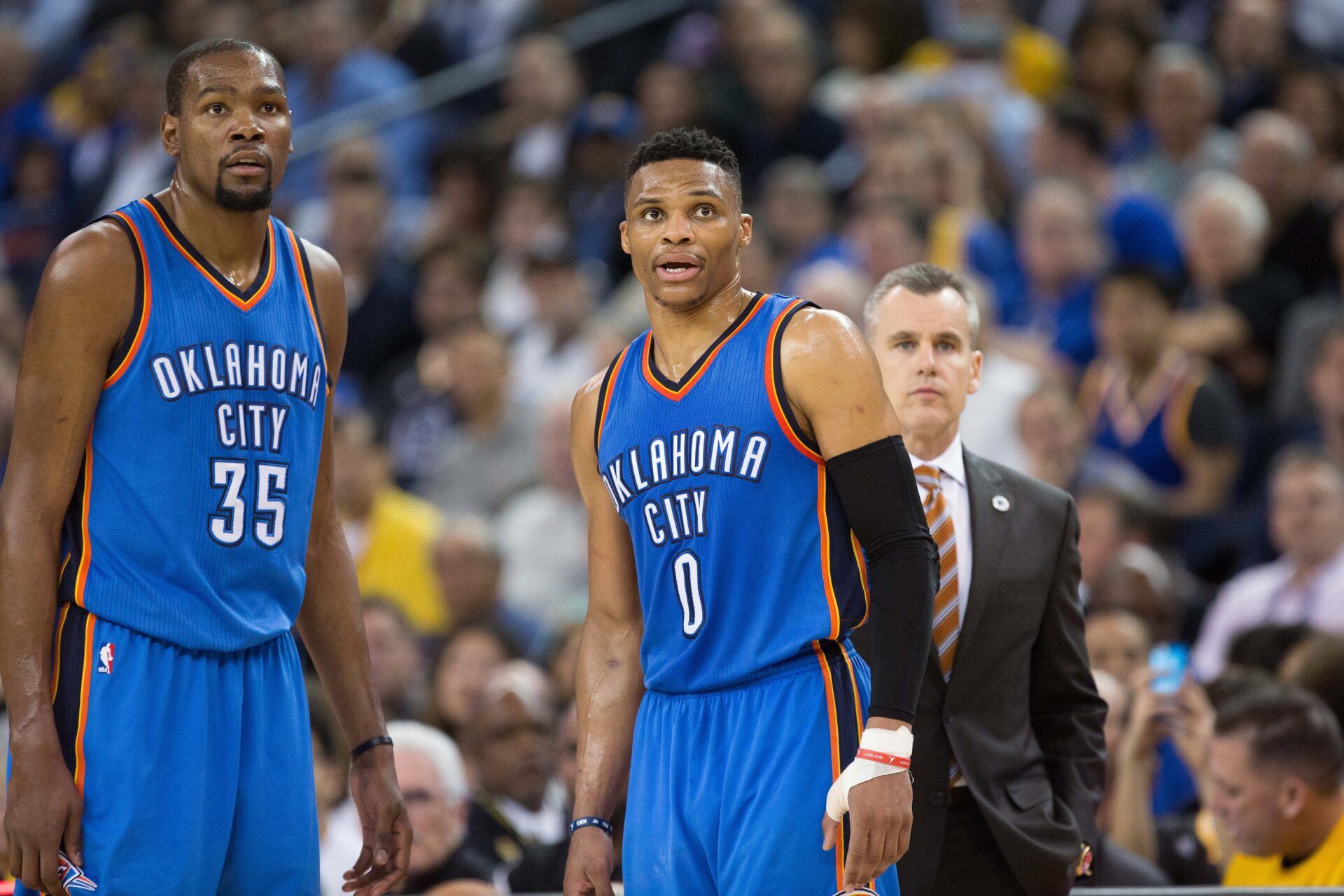 Oklahoma City Thunder forward Kevin Durant (35) and guard Russell Westbrook (0) between plays against the Golden State Warriors during the second quarter at Oracle Arena.