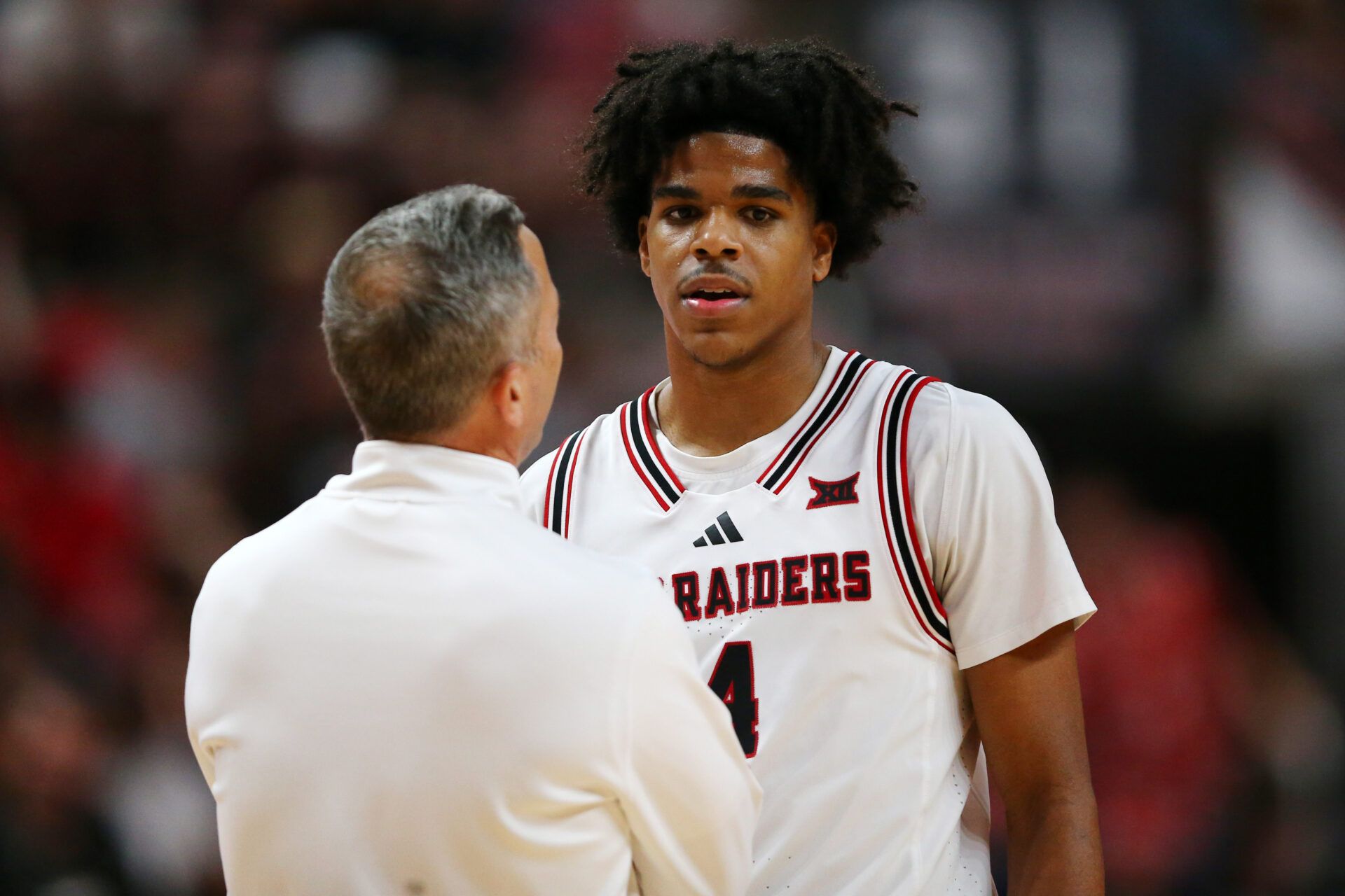 Texas Tech Red Raiders head coach Grant McCasland visits with Texas Tech Red Raiders guard Christian Anderson (4) in the second half of the game against the TCU Horned Frogs at United Supermarkets Arena.
