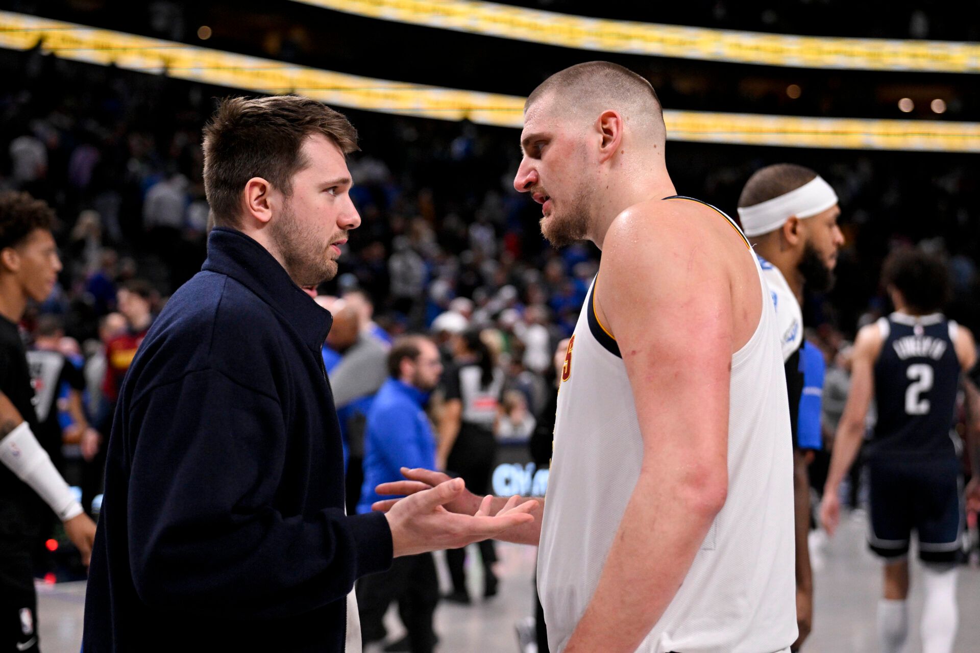 Dallas Mavericks guard Luka Doncic (left) talks with Denver Nuggets center Nikola Jokic (right) after the game at the American Airlines Center.