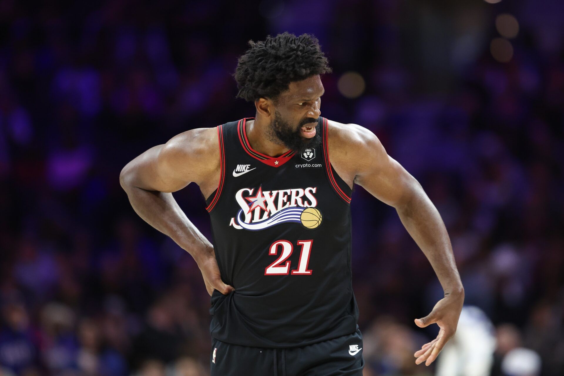 Philadelphia 76ers center Joel Embiid (21) reacts while clutching his body after a play against the Miami Heat during the second quarter at Xfinity Mobile Arena.