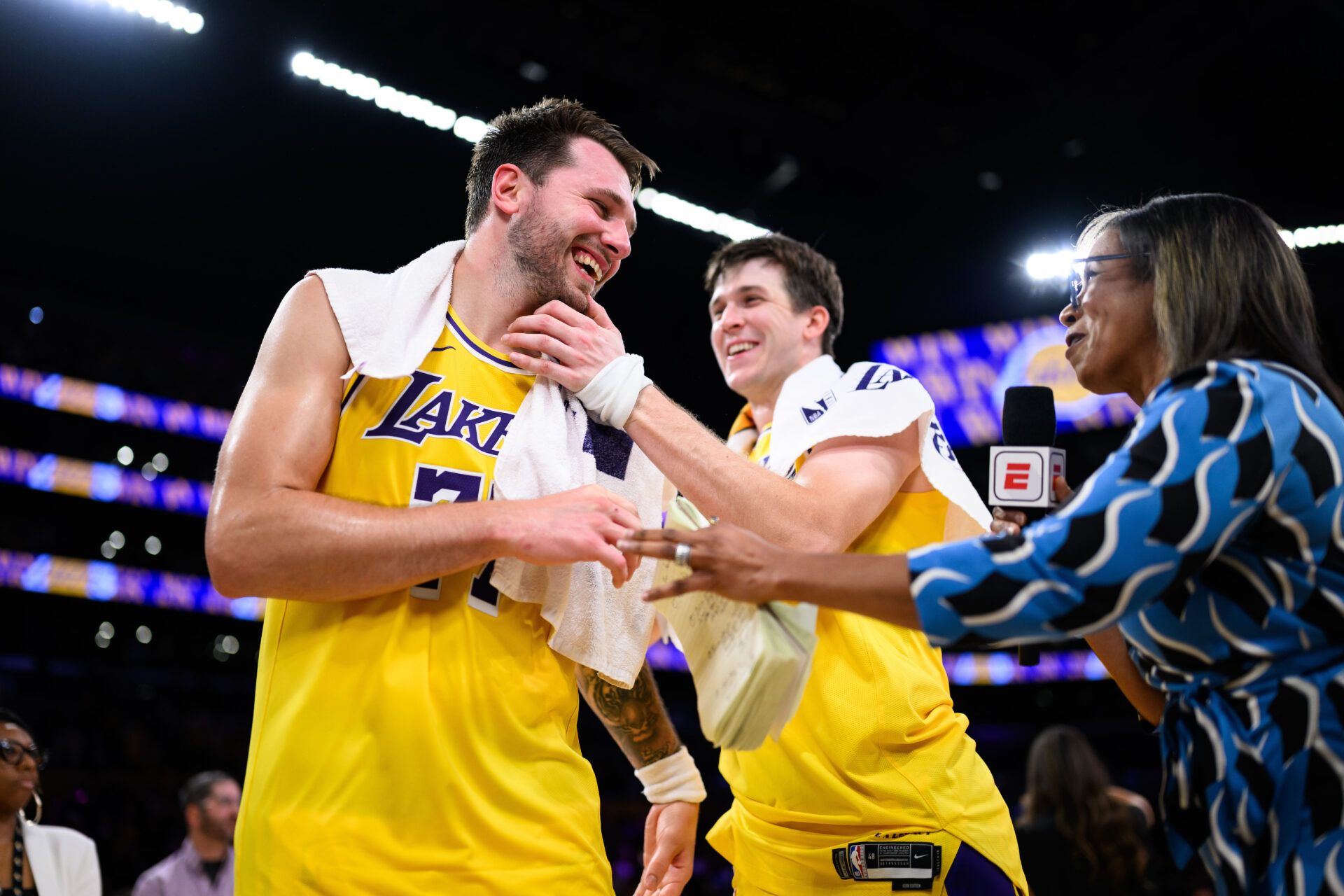 Los Angeles Lakers guard Luka Doncic (77) reacts with guard Austin Reaves (15) after scoring a game winning shot during overtime against the Denver Nuggets at Crypto.com Arena.