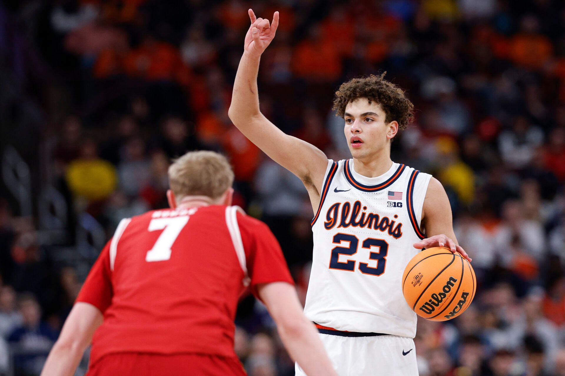 Illinois Fighting Illini guard Keaton Wagler (23) brings the ball up court against Wisconsin Badgers guard Andrew Rohde (7) during the second half at United Center.