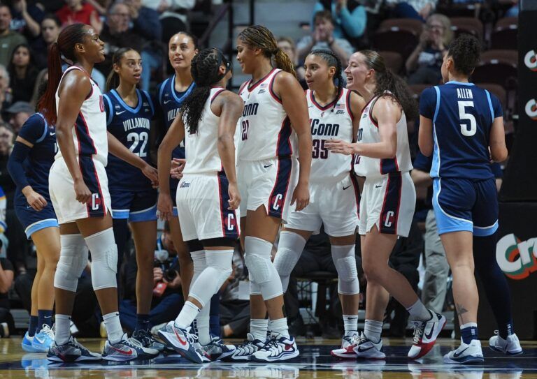 UConn Huskies forward Sarah Strong (21), guard Kk Arnold (2), guard Blanca Quinonez (4), guard Azzi Fudd (35) and guard Ashlynn Shade (12) react after a basket and one against the Villanova Wildcats in the first half at Mohegan Sun Arena.