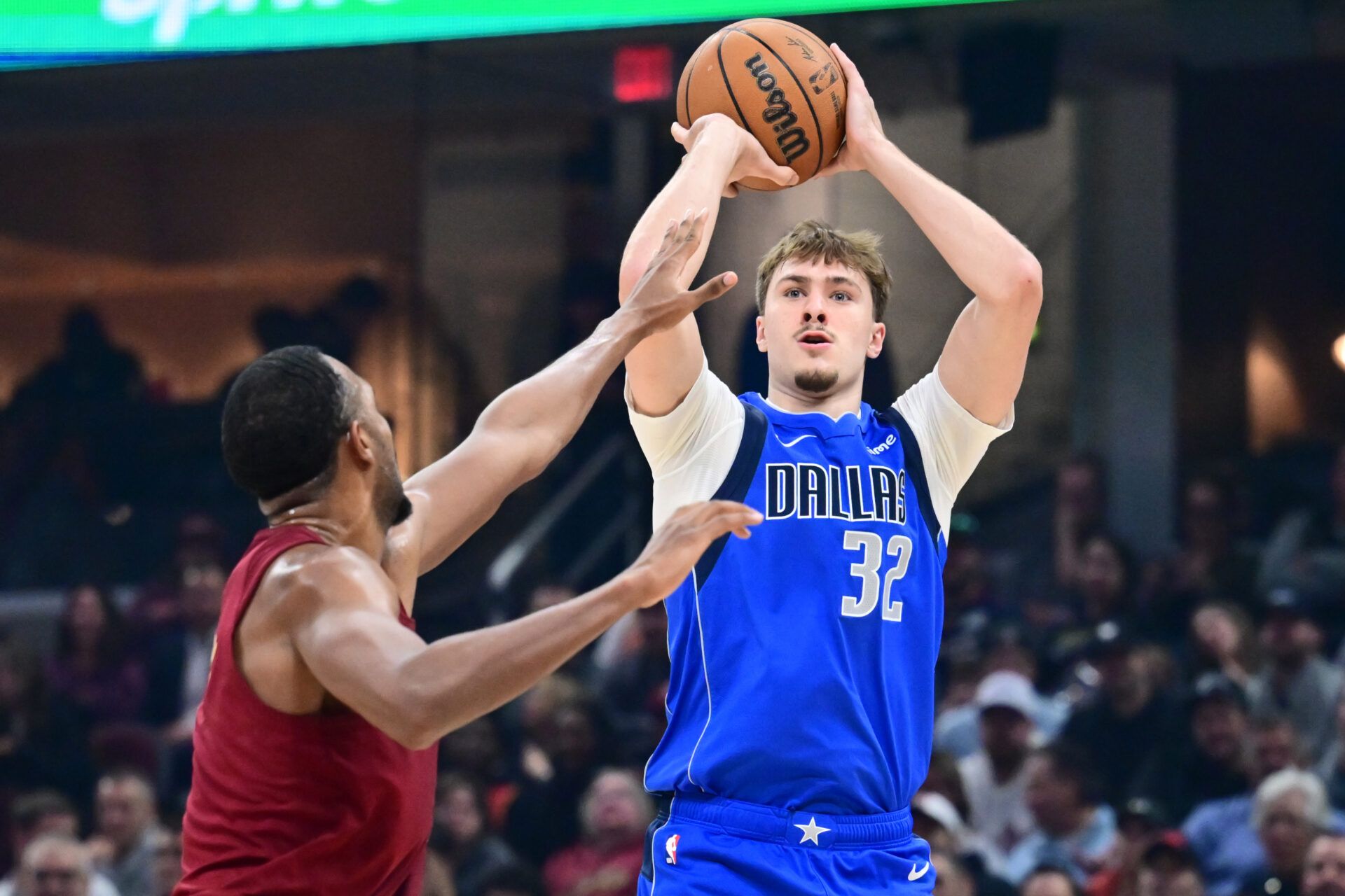 Dallas Mavericks forward Cooper Flagg (32) shoots over the defense of  Cleveland Cavaliers center Evan Mobley (4) during the first half at Rocket Arena.