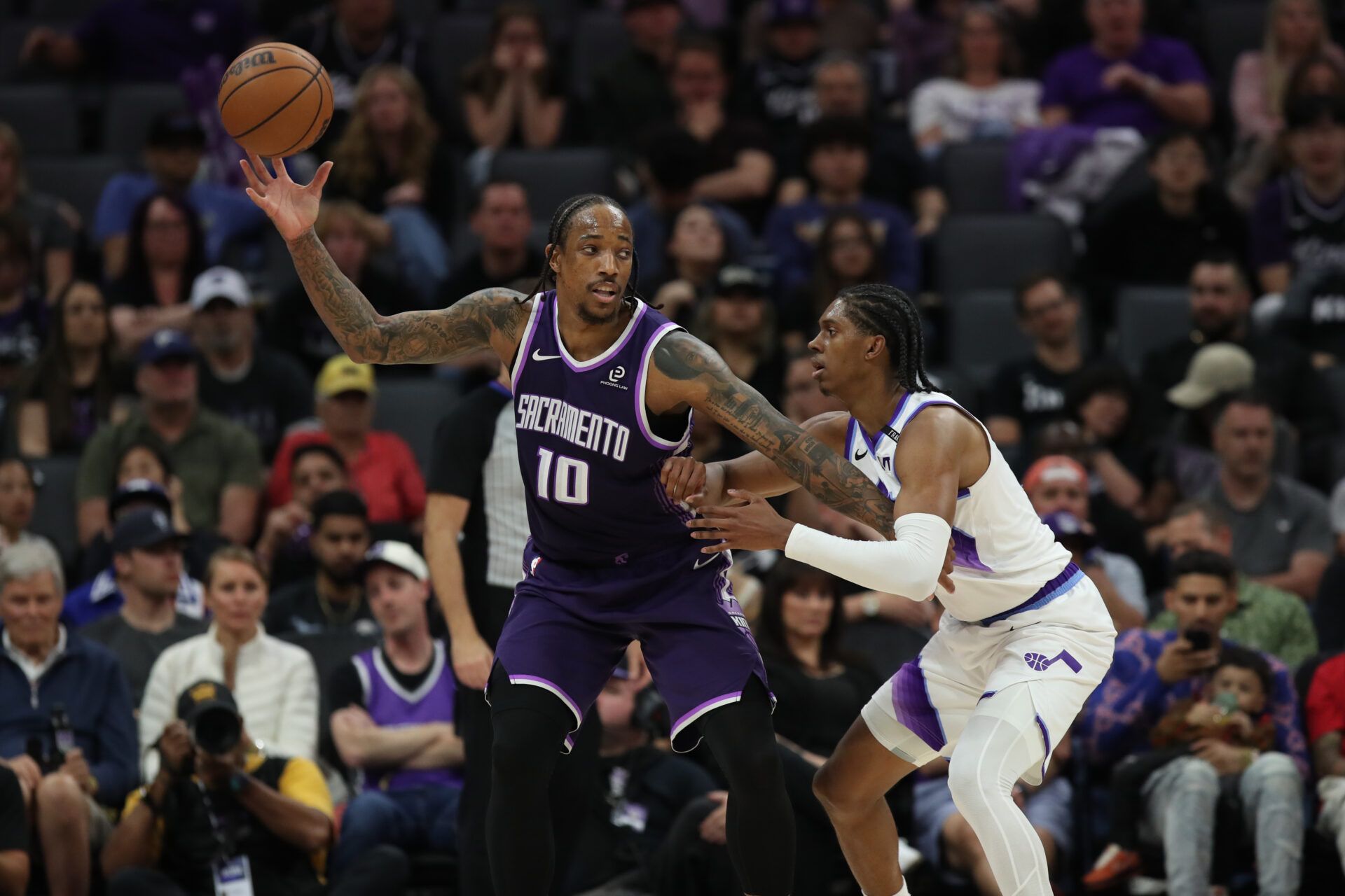 Sacramento Kings guard-forward DeMar DeRozan (10) catches the ball while being defended by Utah Jazz forward Cody Williams (5) during the fourth quarter at Golden 1 Center.