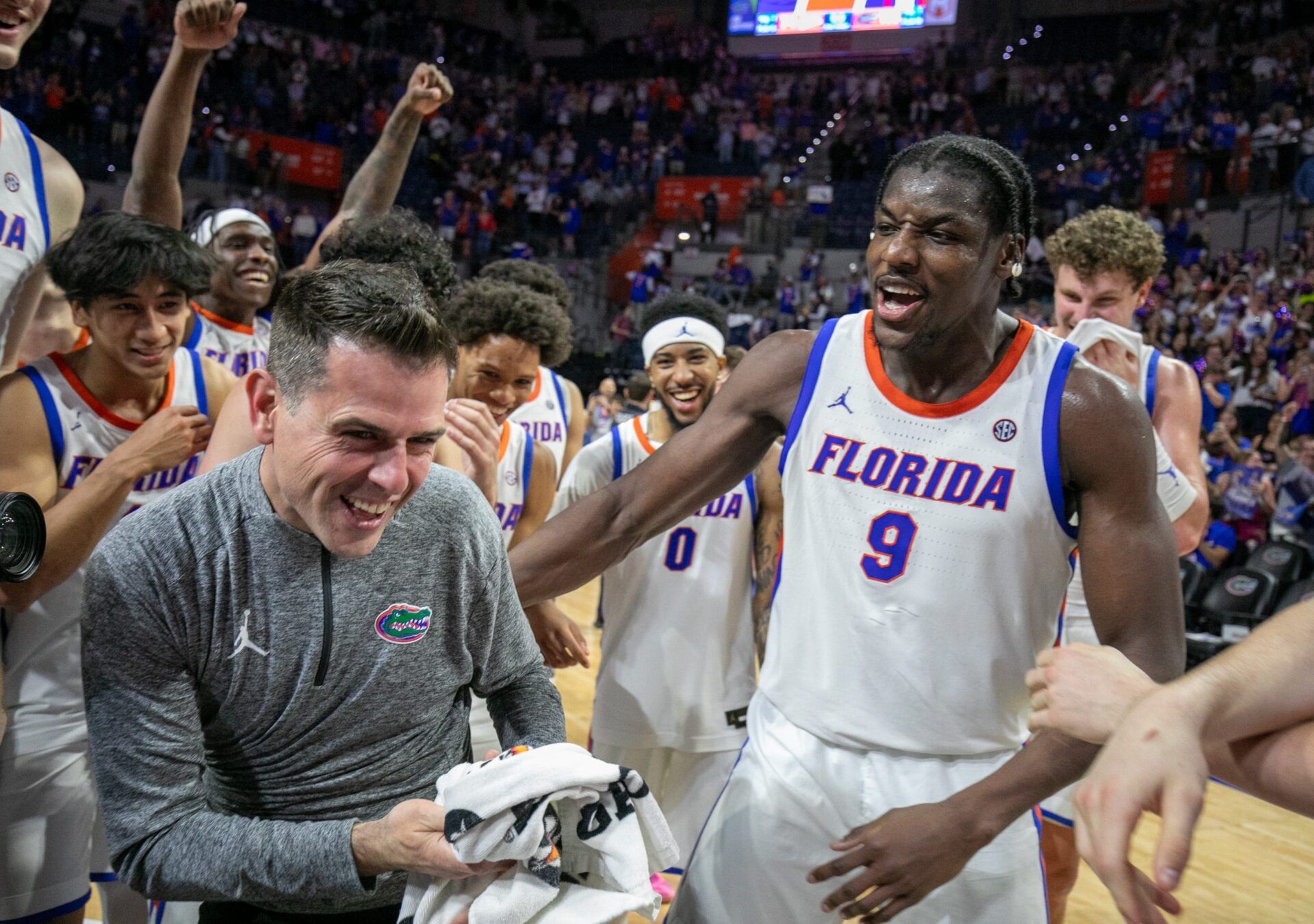Florida head coach Todd Golden celebrates his 100th win and beating Mississippi State 108-77 with Florida center Rueben Chinyelu (9) and the rest of the team after an NCAA mens basketball game at Steven C. O'Connell Center Exactek arena in Gainesville, FL on Tuesday, March 3, 2026. [Alan Youngblood/Gainesville Sun]