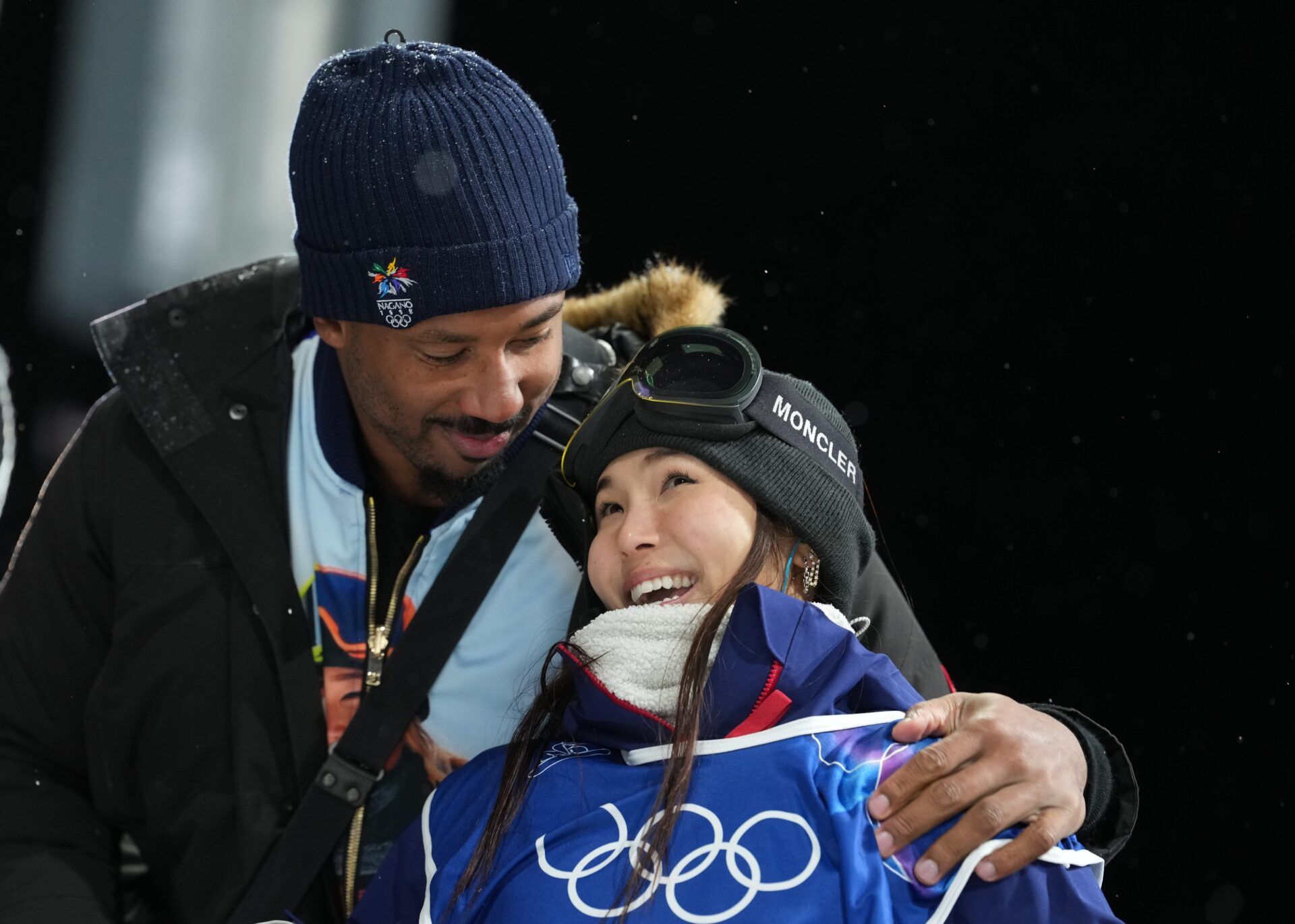 Chloe Kim of the United States with Cleveland Browns player Myles Garrett after her second run in the women's halfpipe final during the Milano Cortina 2026 Olympic Winter Games at Livigno Snow Park.