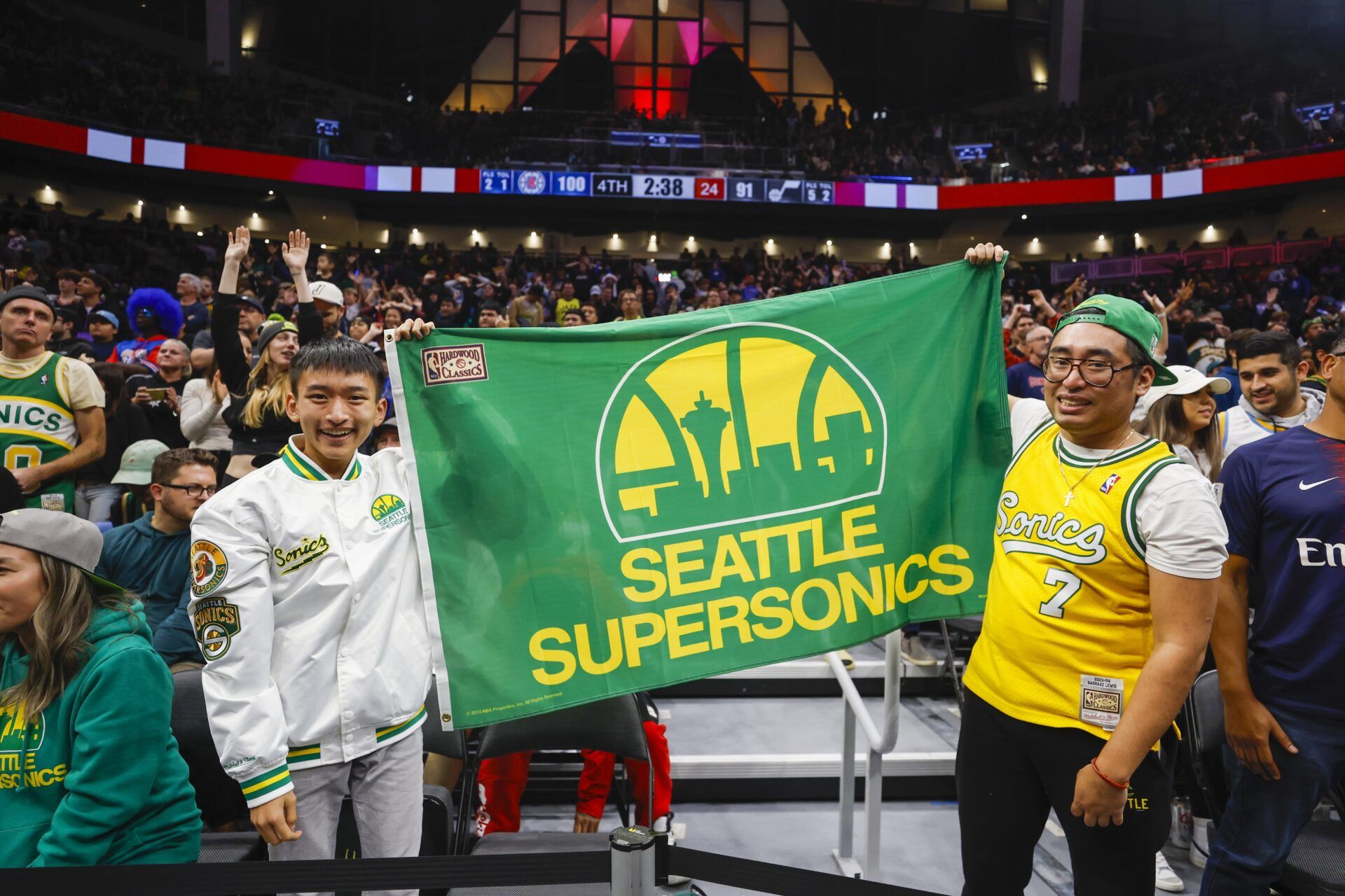 Fans hold a flag for the Seattle Supersonics during the fourth quarter of a game between the Utah Jazz and LA Clippers at Climate Pledge Arena.