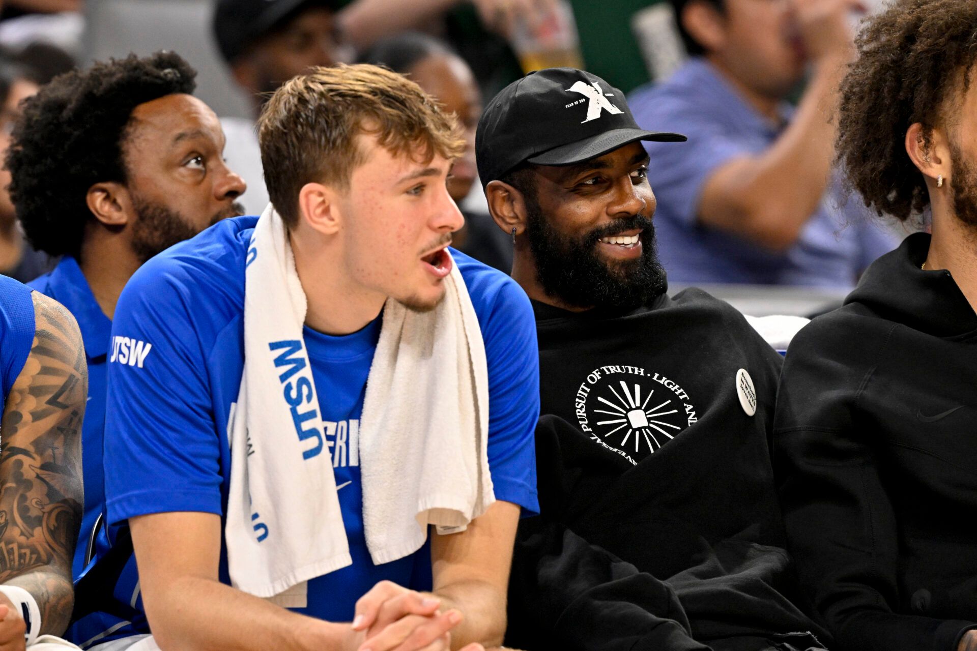 Dallas Mavericks forward Cooper Flagg (left) and guard Kyrie Irving (right) watch the game against the Oklahoma City Thunder during the second half at Dickie's Arena.