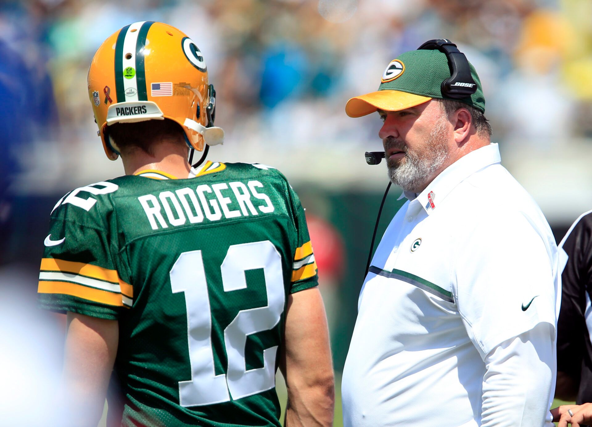 Green Bay Packers head coach Mike McCarthy talks with quarterback Aaron Rodgers (12) during the first half of  a football game against the Jacksonville Jaguars at EverBank Field.