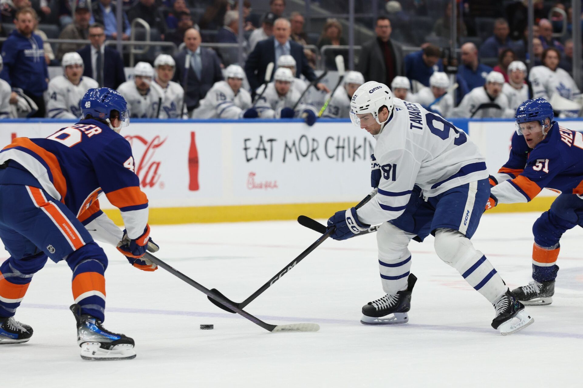 Toronto Maple Leafs center John Tavares (91) skates with the puck defended by New York Islanders defenseman Matthew Schaefer (48) during the third period at UBS Arena.