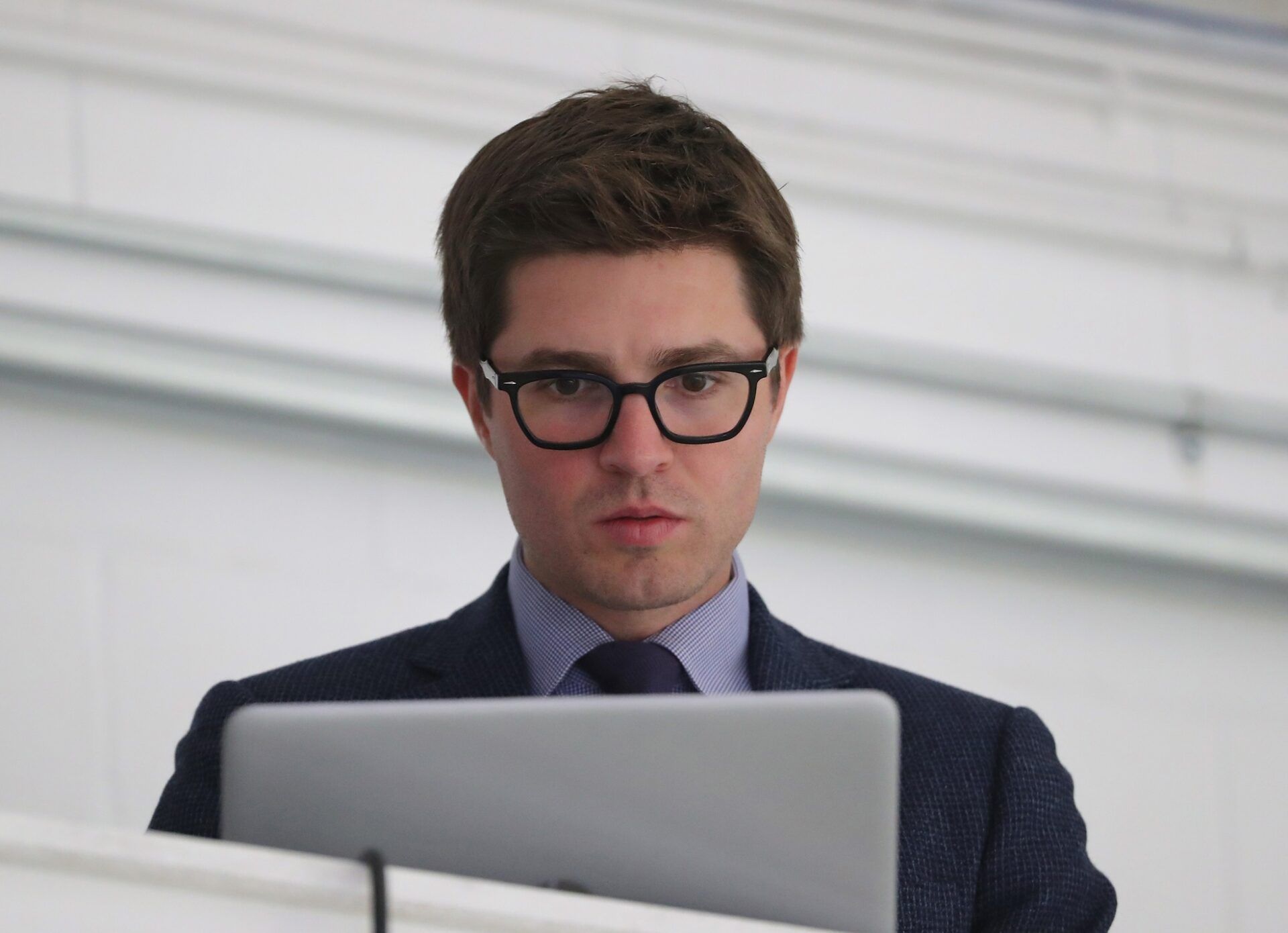 Toronto Maple Leafs general manager Kyle Dubas on his laptop before the start of their game against the Ottawa Senators at Lucan Community Memorial Centre.  The Maple Leafs beat the Senators 4-1.
