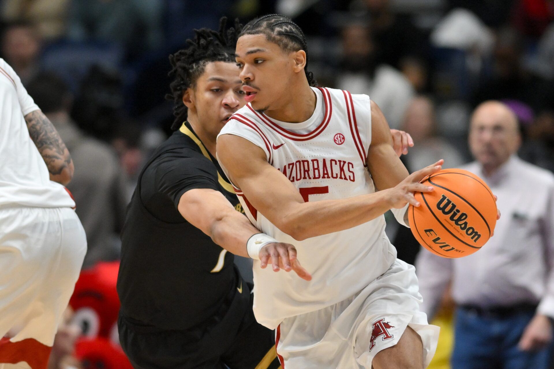 Arkansas Razorbacks guard Darius Acuff Jr. (5) dribbles the ball defended by Vanderbilt Commodores guard Chandler Bing (7) in the second half during the men's SEC Conference Tournament Championship at Bridgestone Arena.