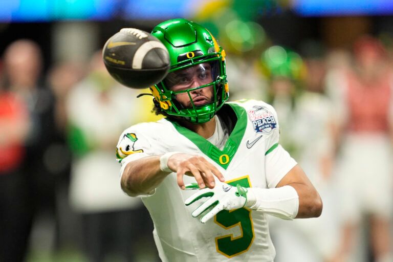 Oregon Ducks quarterback Dante Moore (5) throws a pass during the fourth quarter the 2025 Peach Bowl and semifinal game of the College Football Playoff at Mercedes-Benz Stadium.