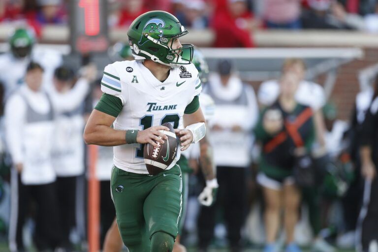 Tulane Green Wave quarterback Jake Retzlaff (12) rolls out against the Mississippi Rebels during the first half of a game at Vaught-Hemingway Stadium.