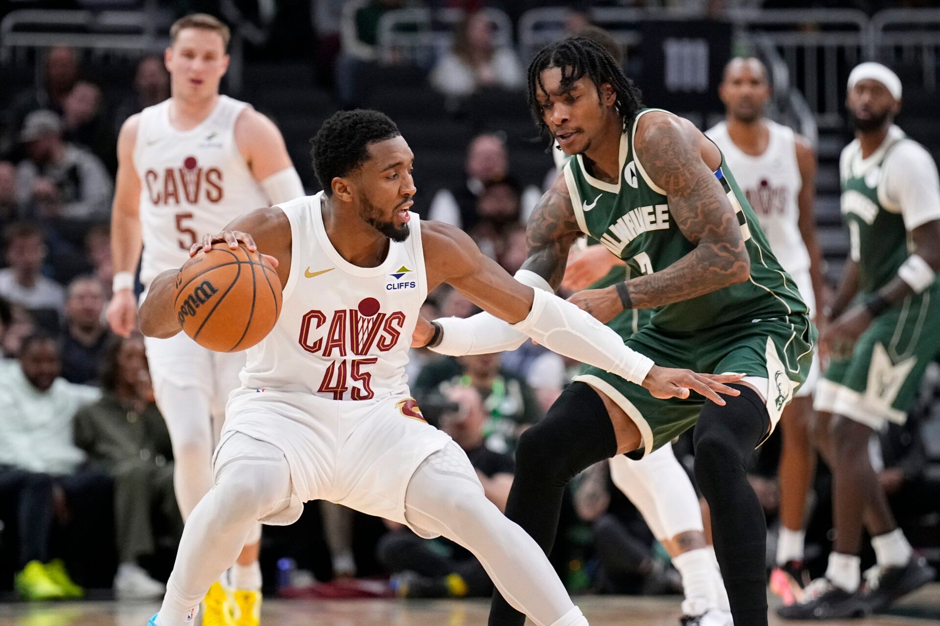 Cleveland Cavaliers guard Donovan Mitchell (45) drives against Milwaukee Bucks guard/forward Kevin Porter Jr. (7) in the second half at Fiserv Forum.
