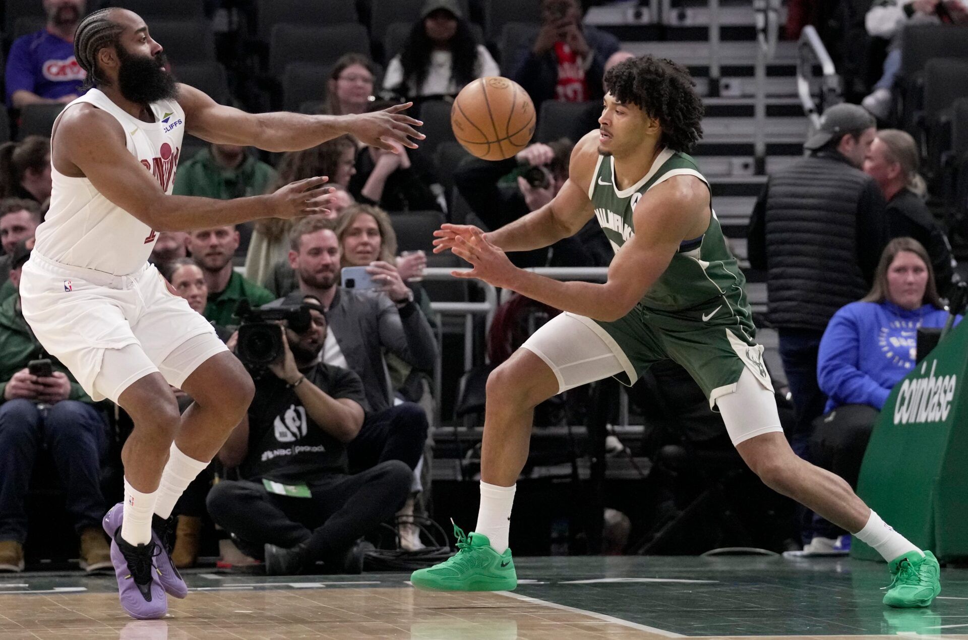 Cavaliers guard James Harden passes the ball around Bucks center Jericho Sims during the first half.