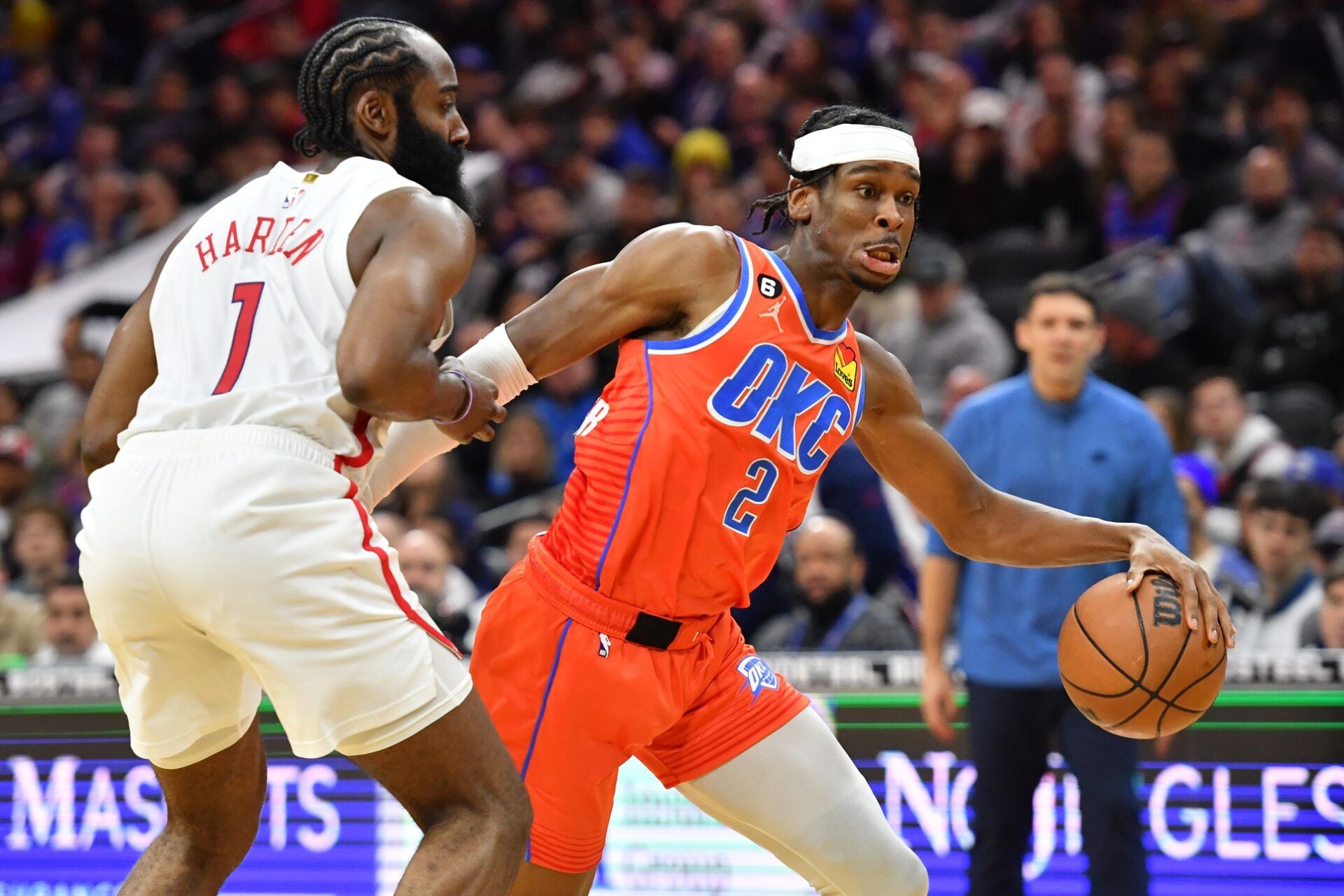 Oklahoma City Thunder guard Shai Gilgeous-Alexander (2) drives to the basket against Philadelphia 76ers guard James Harden (1) during the fourth quarter at Wells Fargo Center.