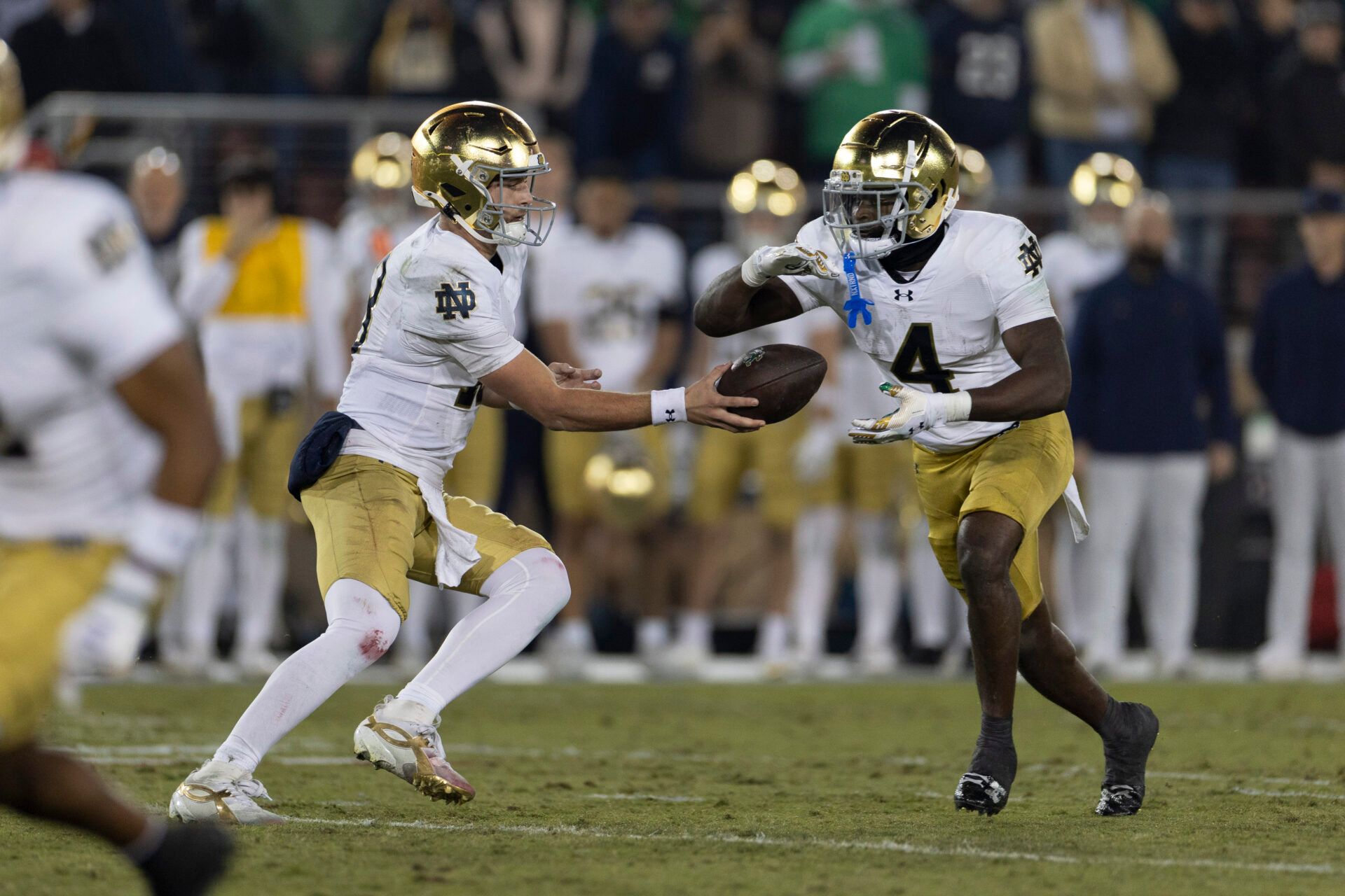 Notre Dame Fighting Irish quarterback CJ Carr (13) hands the ball off to Notre Dame Fighting Irish running back Jeremiyah Love (4) during the first quarter against the Stanford Cardinal at Stanford Stadium.