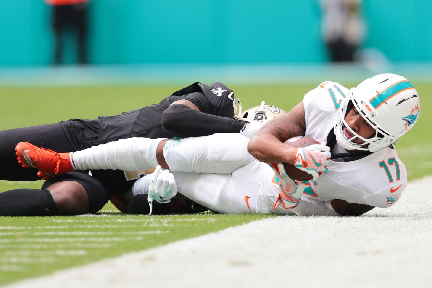 Miami Dolphins wide receiver Jaylen Waddle (17) makes the catch as New Orleans Saints cornerback Kool-Aid McKinstry (4) defends during the first half at Hard Rock Stadium.