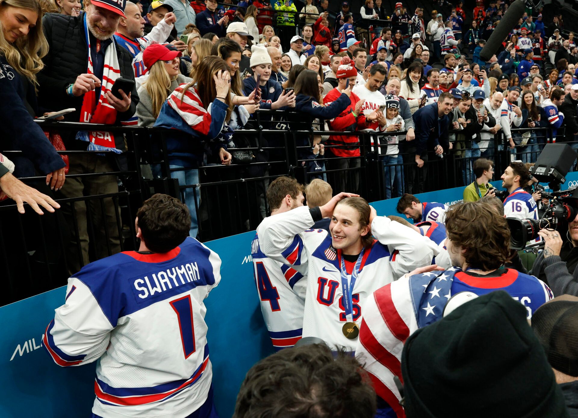 Jack Hughes (86) of the United States celebrates with fans after defeating Canada in the men's ice hockey gold medal game during the Milano Cortina 2026 Olympic Winter Games at Milano Santagiulia Ice Hockey Arena.