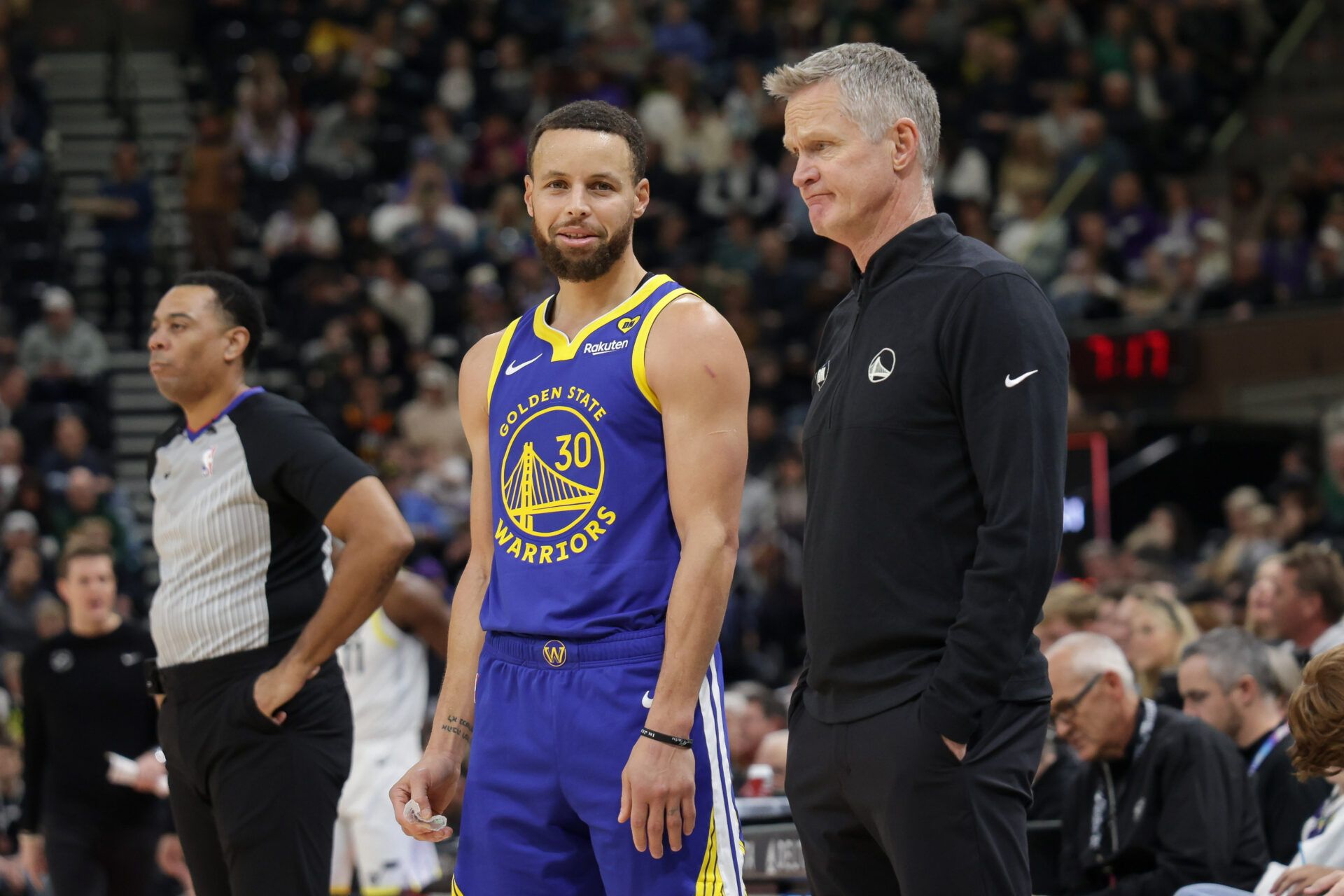 Golden State Warriors guard Stephen Curry (30) and head coach Steve Kerr talk on the sideline during the first quarter against the Utah Jazz at Delta Center.