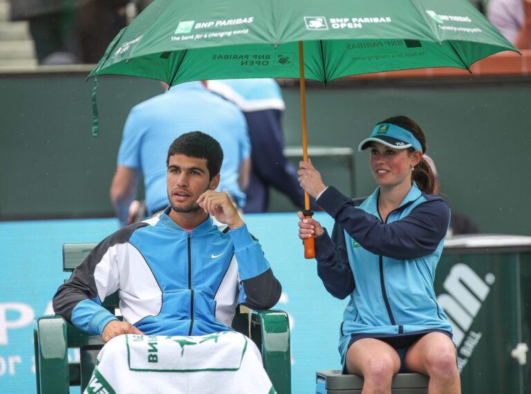 Carlos Alcaraz takes shelter from a light rain that suspended play in the mens semifinal match with Jannik Sinner at the BNP Paribas Open in Indian Wells, Calif., March 16, 2024.