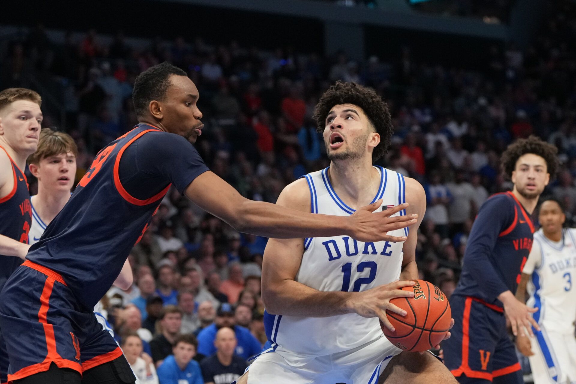 Duke Blue Devils forward Cameron Boozer (12) withj the ball as Virginia Cavaliers center Ugonna Onyenso (33) defends in the second half during the men's ACC Conference Tournament Championship at Spectrum Center.