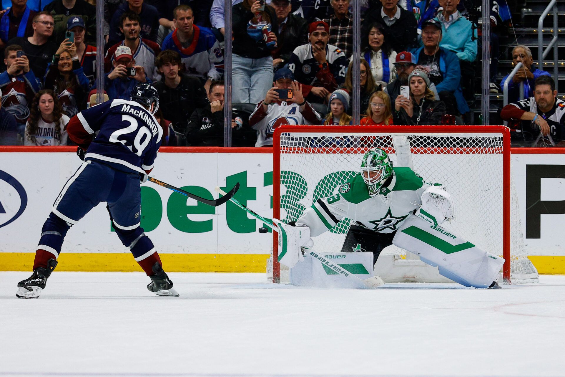 Colorado Avalanche center Nathan MacKinnon (29) shoots the puck wide of the net against Dallas Stars goaltender Jake Oettinger (29) in the shootout at Ball Arena.