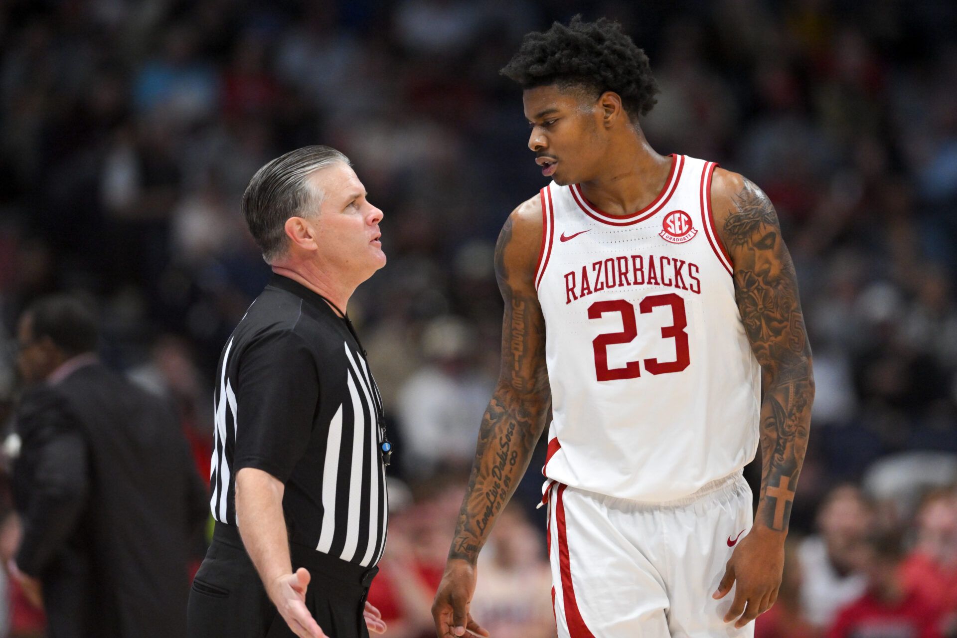 Arkansas Razorbacks forward Nick Pringle (23) speaks with official 
Joe Lindsay in the second half during the men's SEC Conference Tournament Championship against the Vanderbilt Commodores at Bridgestone Arena.