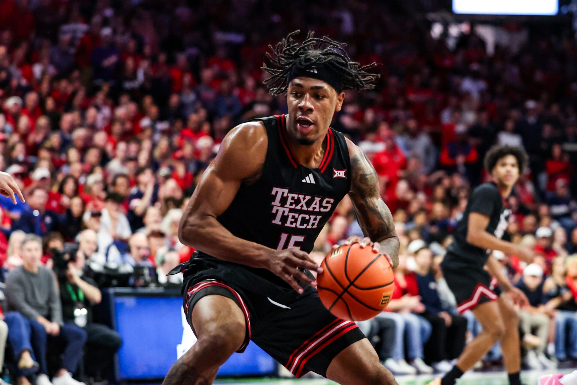 Texas Tech Red Raiders forward JT Toppin (15) dribbles and dunks the ball during the first half of the game against the Arizona Wildcats at McKale Memorial Center.