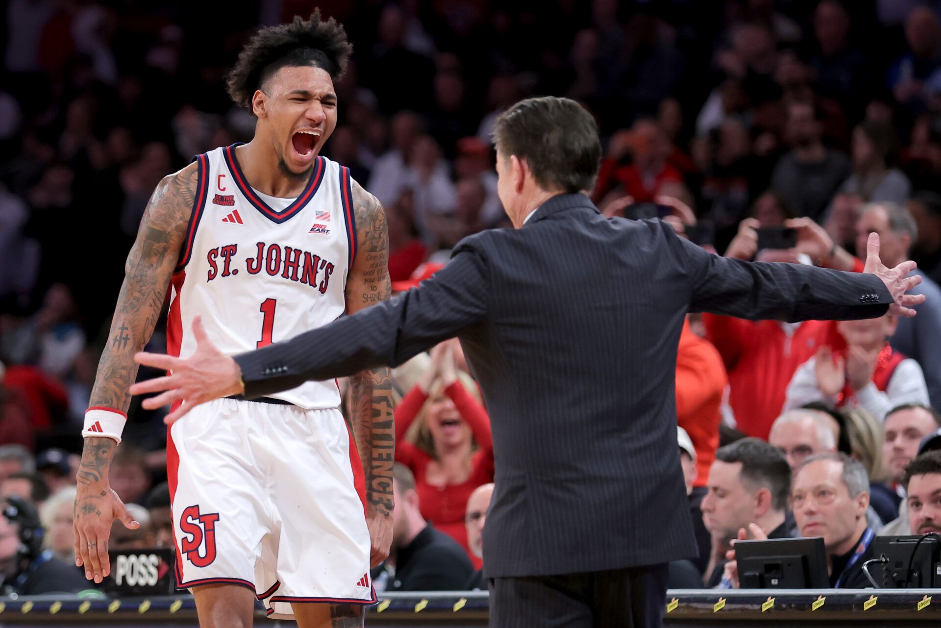 St. John's Red Storm head coach Rick Pitino hugs forward Dillon Mitchell (1) during the final seconds of the second half of the men's Big East Conference Tournament Championship game against the Connecticut Huskies at Madison Square Garden.