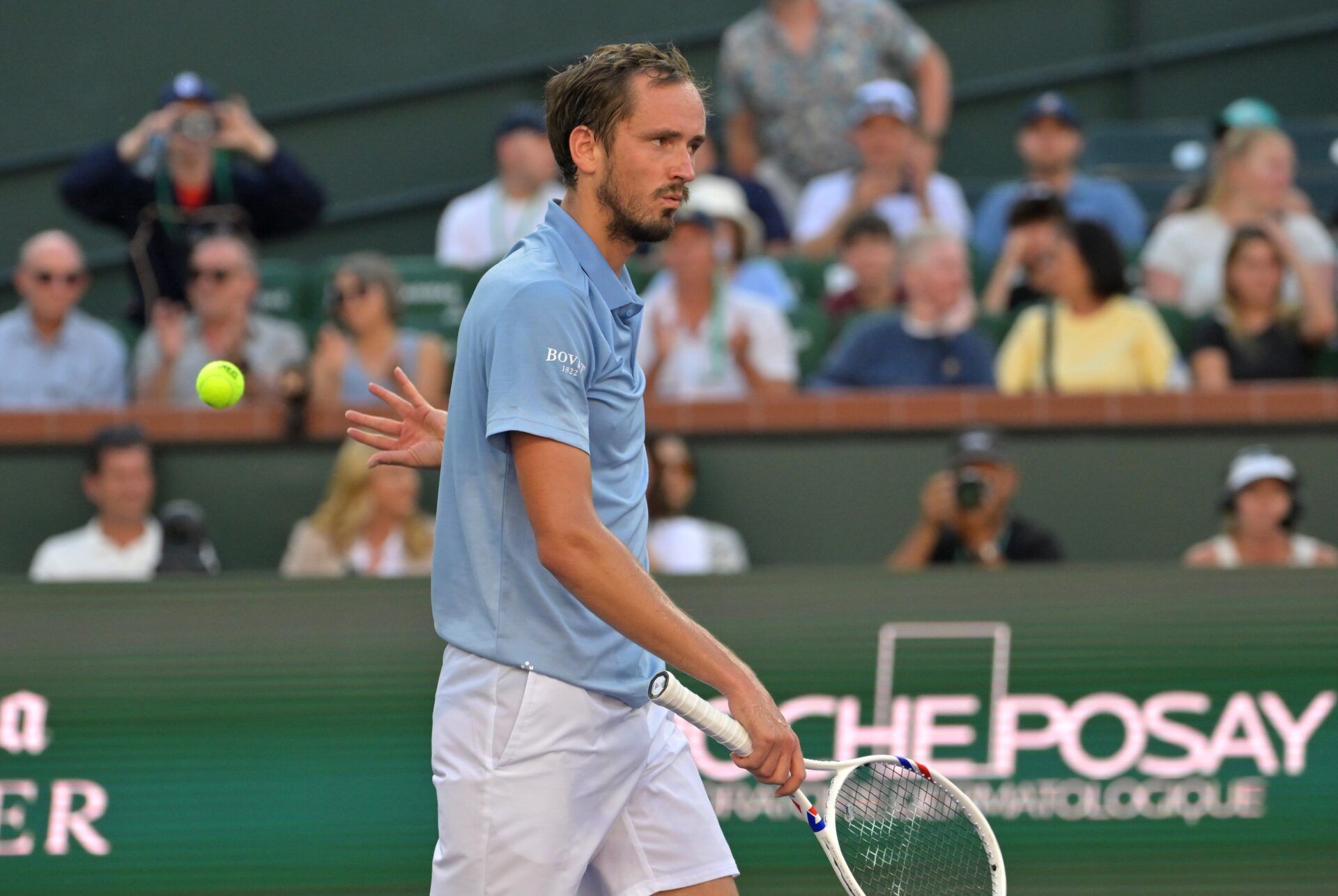 Daniil Medvedev (RUS) tosses the ball and approaches the net after defeating Carlos Alcaraz (ESP) in the semifinal match of the BNP Paribas Open at the Indian Wells Tennis Garden.